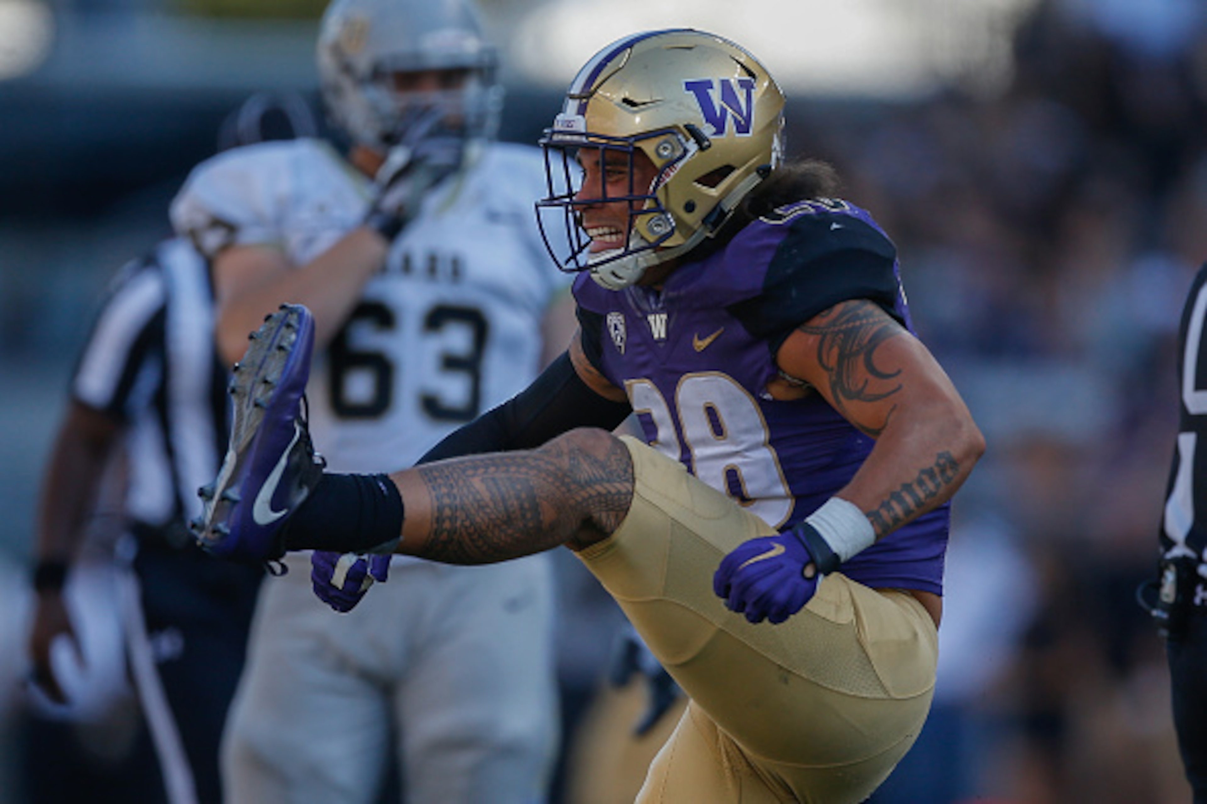 SEATTLE, WA - SEPTEMBER 10:  Linebacker Psalm Wooching #28 of the Washington Huskies reacts after tackling quarterback Matt Linehan of the Idaho Vandals in the second quarter on September 10, 2016 at Husky Stadium in Seattle, Washington.  (Photo by Otto G