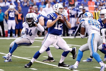 INDIANAPOLIS, IN - SEPTEMBER 11: Andrew Luck #12 of the Indianapolis Colts prepares to pass the ball while being rushed by the Devin Taylor #98 of the Detroit Lions and Ezekiel Ansah #94 of the Detroit Lions during the third quarter of the game against th