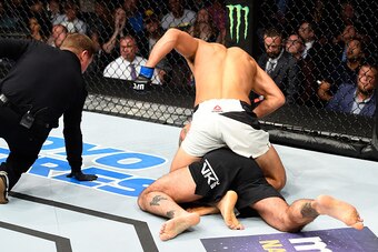 CLEVELAND, OH - SEPTEMBER 10:  Mickey Gall (top) punches Phil 'CM Punk' Brooks in their welterweight bout during the UFC 203 event at Quicken Loans Arena on September 10, 2016 in Cleveland, Ohio. (Photo by Josh Hedges/Zuffa LLC/Zuffa LLC via Getty Images)