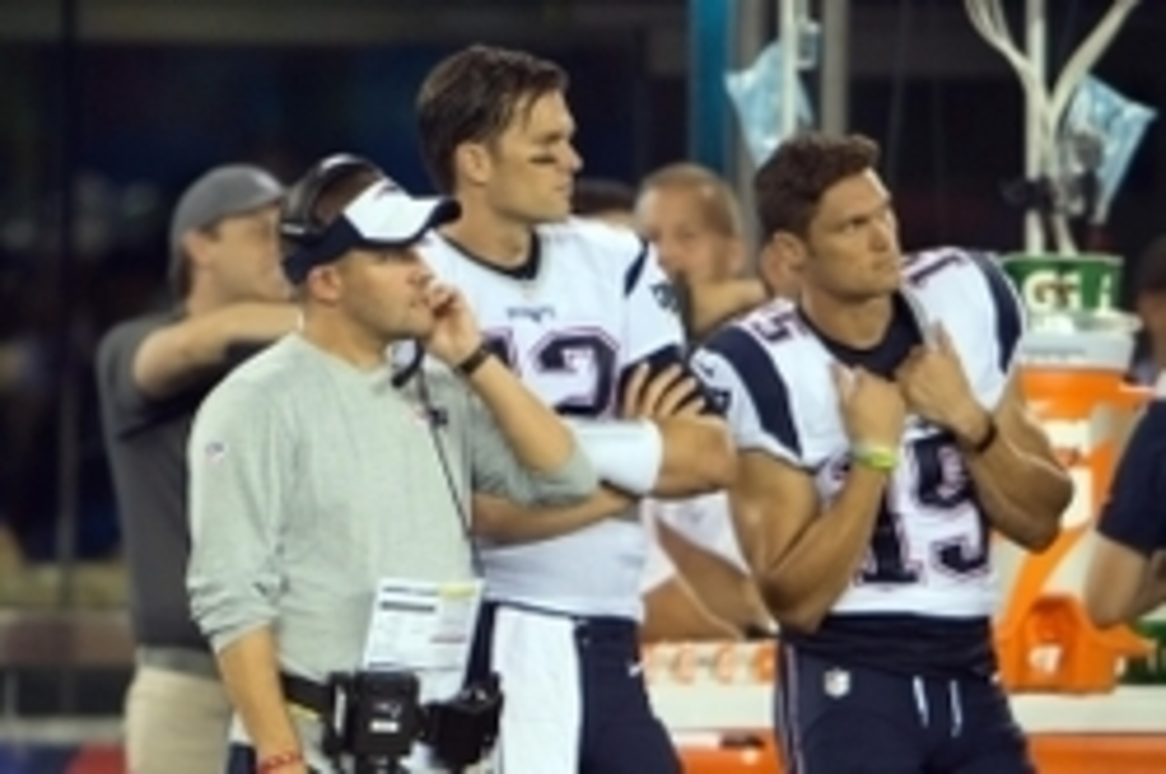 Sep 1, 2016; East Rutherford, NJ, USA; New England Patriots offensive coordinator Josh McDanials looks on with New England Patriots quarterback Tom Brady (12) and New England Patriots wide receiver Chris Hogan (15) in the second half at MetLife Stadium. T