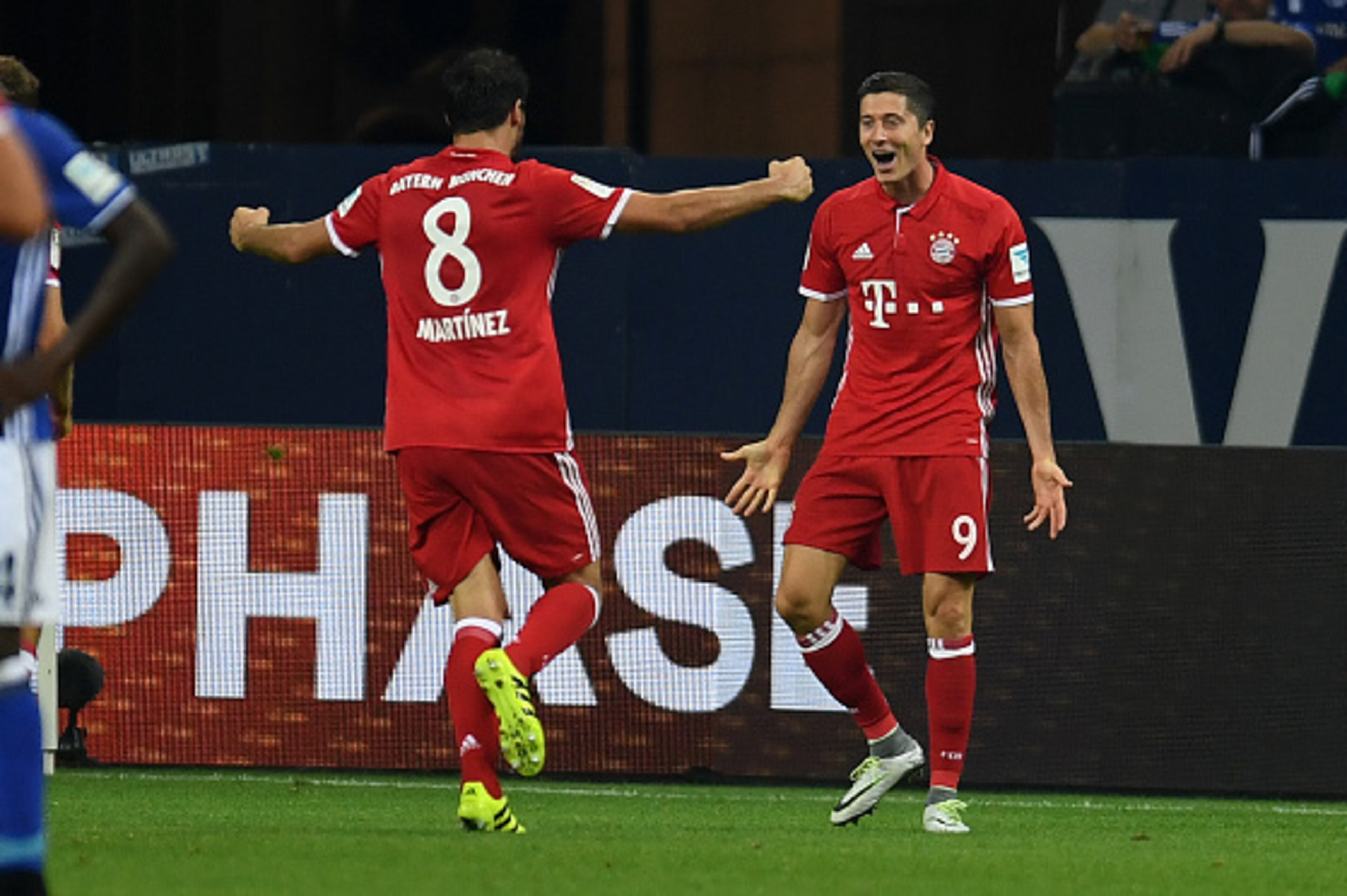 Bayern Munich's Polish striker Robert Lewandowski (R) celebrate scoring the opening goal with  Spanish teammate Javier Martinez during the German first division Bundesliga football match between Schalke 04 and FC Bayern Munich in Gelsenkirchen, western Ge