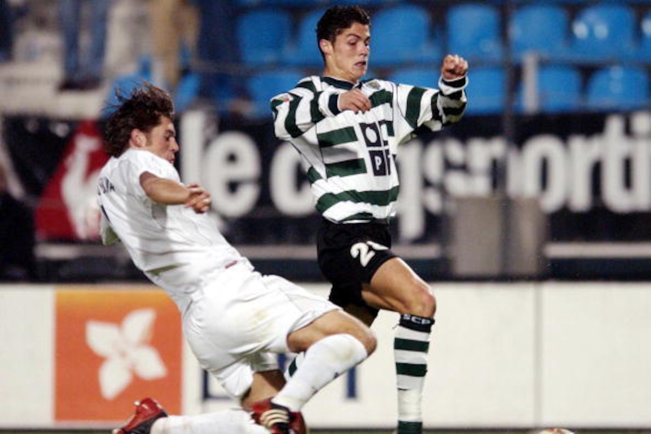 PORTO, PORTUGAL:  Vitoria de Guimaraes's Ricardo Silva (L) vies with Sporting's Cristiano Ronaldo in a Portuguese league match 08 November 2002 at Antas Stadium in Porto. (Photo credit should read ANTONIO SIMOES/AFP/Getty Images)