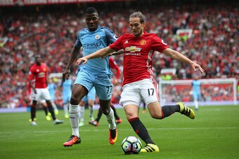 MANCHESTER, ENGLAND - SEPTEMBER 10: Daley Blind of Manchester United is closed down by Kelechi Iheanacho of Manchester City during the Premier League match between Manchester United and Manchester City at Old Trafford on September 10, 2016 in Manchester, 