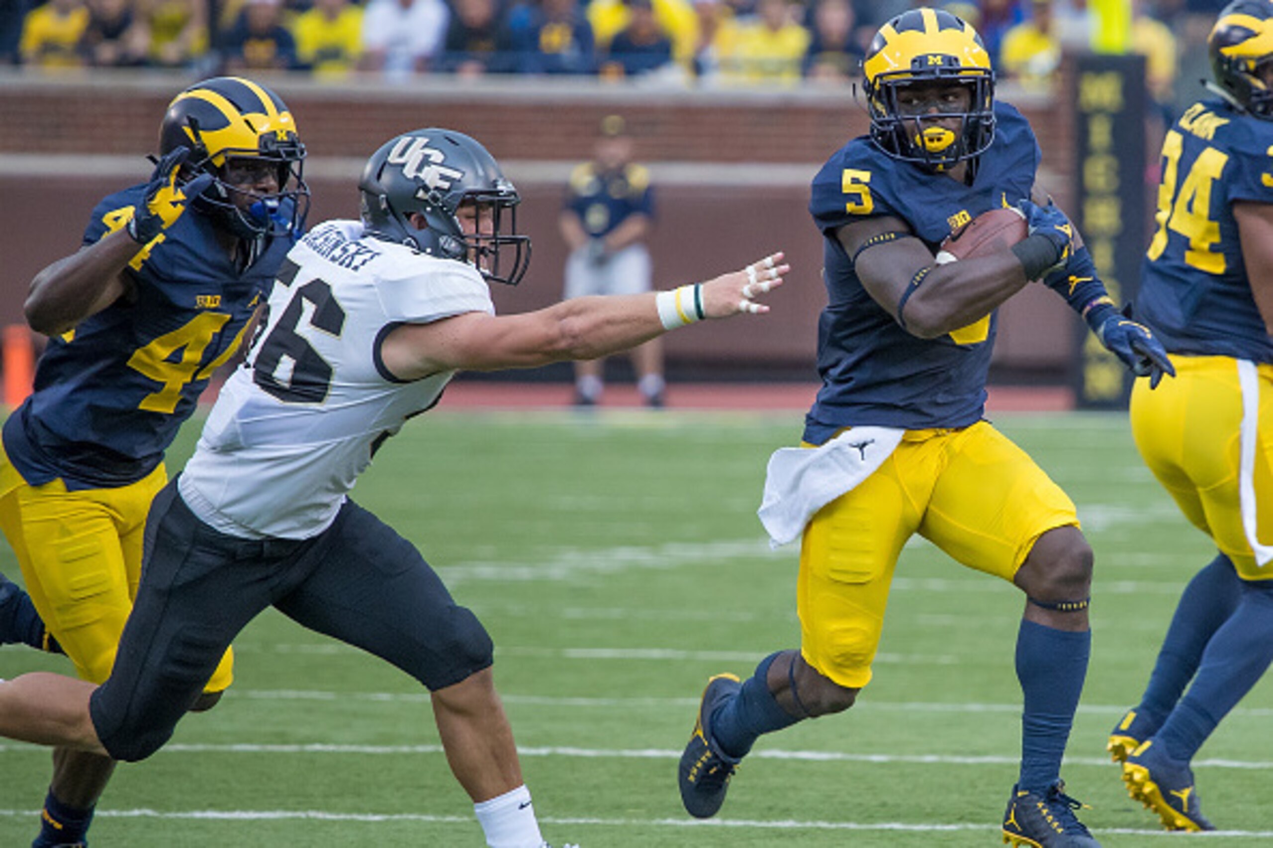 DETROIT, MI - SEPTEMBER 10: Linebacker Jabrill Peppers #5 of the Michigan Wolverines run with the football in front of linebacker Pat Jasinski #56 of the UCF Knights during a college football game at Michigan Stadium on September 10, 2016 in Ann Arbor, Mi