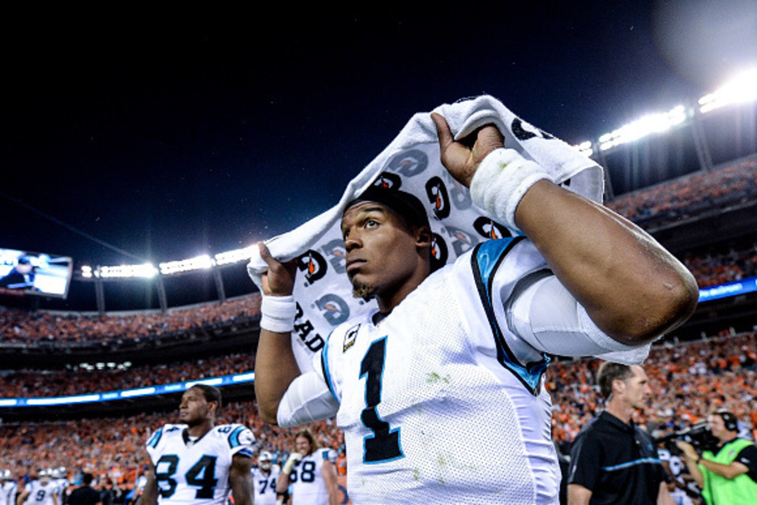 DENVER, CO - SEPTEMBER 8: Quarterback Cam Newton #1 of the Carolina Panthers places a towel over his head after a game against the Denver Broncosat Sports Authority Field at Mile High on September 8, 2016 in Denver, Colorado. (Photo by Dustin Bradford/Ge DENVER, CO - SEPTEMBER 8: Quarterback Cam Newton #1 of the Carolina Panthers places a towel over his head after a game against the Denver Broncosat Sports Authority Field at Mile High on September 8, 2016 in Denver, Colorado. (Photo by Dustin Bradford/Ge