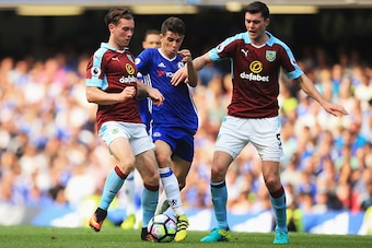 LONDON, ENGLAND - AUGUST 27: Oscar of Chelsea (C) attempts to get past (L) Jon Flanagan of Burnley and Michael Keane Eof Burnley (R) during the Premier League match between Chelsea and Burnley at Stamford Bridge on August 27, 2016 in London, England.  (Ph