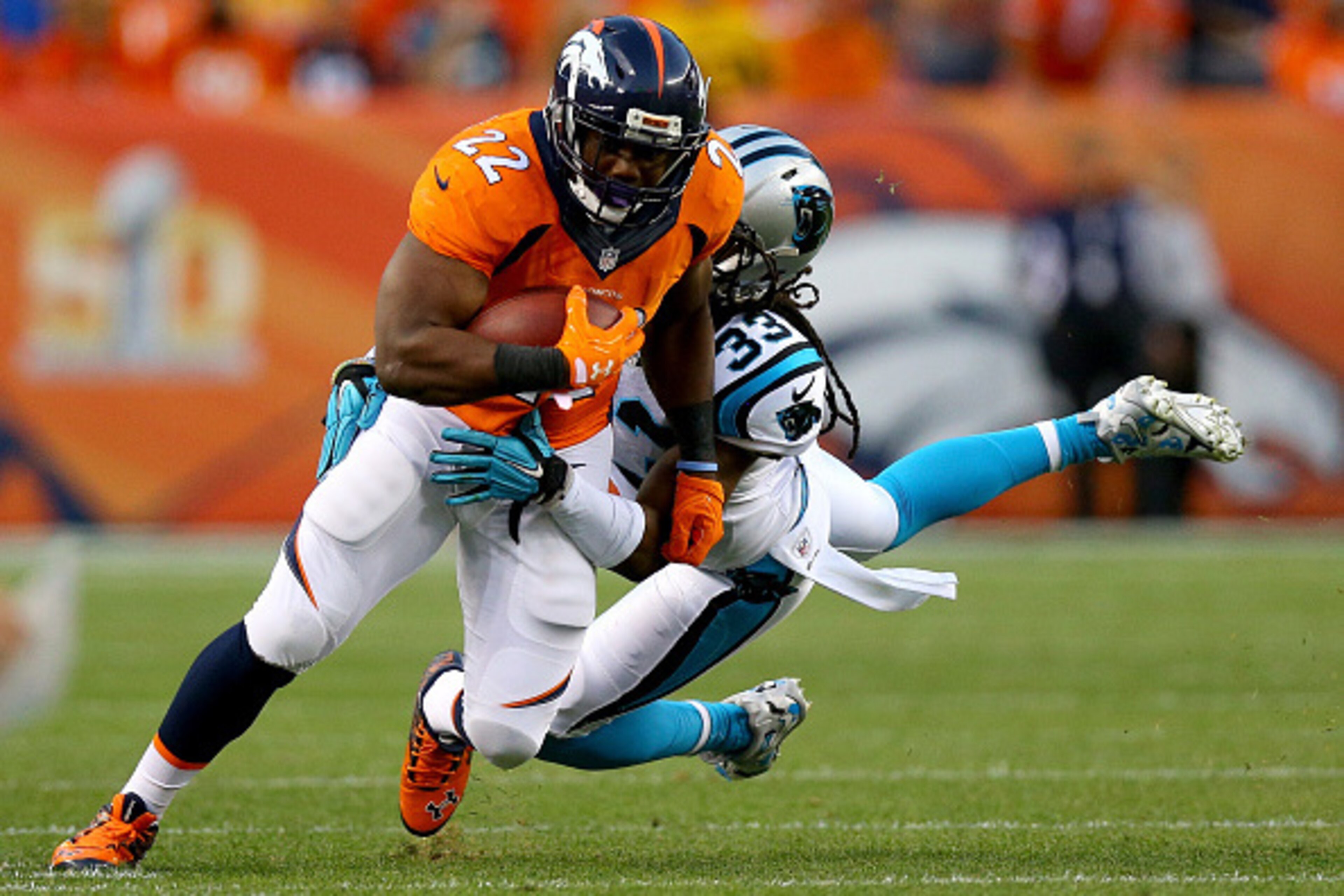 DENVER, CO - SEPTEMBER 08:  Running back C.J. Anderson #22 of the Denver Broncos runs the ball against free safety Tre Boston #33 of the Carolina Panthers in the first half at Sports Authority Field at Mile High on September 8, 2016 in Denver, Colorado.  