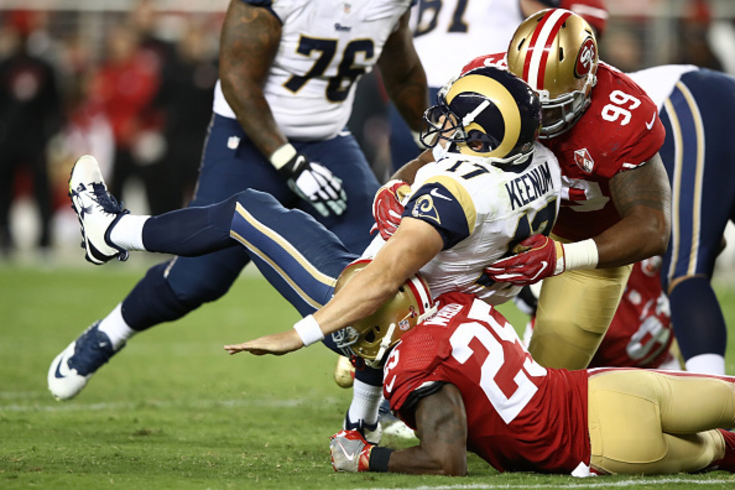 SANTA CLARA, CA - SEPTEMBER 12:  Case Keenum #17 of the Los Angeles Rams is tackled by Jimmie Ward #25 and DeForest Buckner #99 of the San Francisco 49ers during their NFL game at Levi's Stadium on September 12, 2016 in Santa Clara, California.  (Photo by