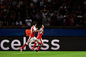 Arsenal's Chilean forward Alexis Sanchez (C) celebrates after scoring with his teammate Arsenal's Spanish defender Hector Bellerin during the UEFA Champions League Group A football match between Paris-Saint-Germain vs Arsenal FC, on September 13, 2016 at 