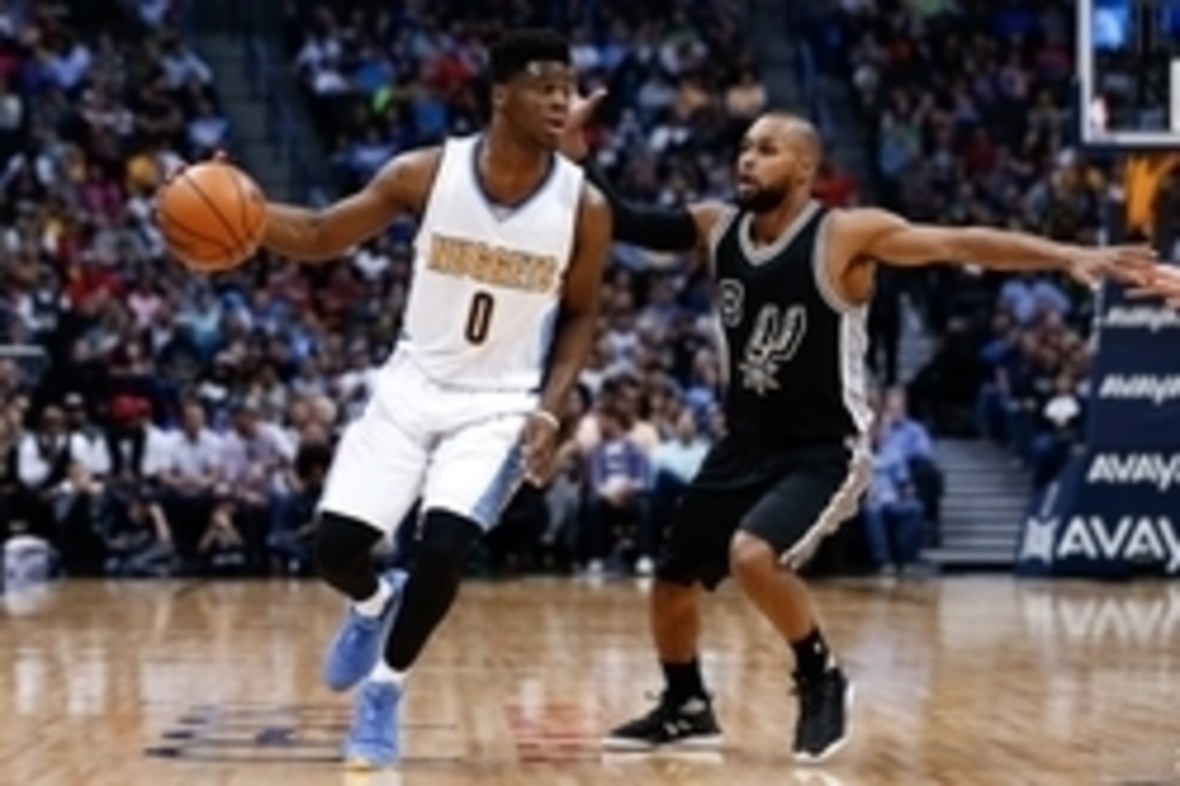Apr 8, 2016; Denver, CO, USA; San Antonio Spurs guard Patty Mills (8) guards Denver Nuggets guard Emmanuel Mudiay (0) in the third quarter at the Pepsi Center. The Nuggets defeated the Spurs 102-98. Mandatory Credit: Isaiah J. Downing-USA TODAY Sports