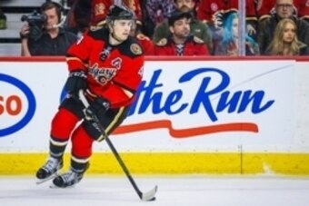 Jan 27, 2016; Calgary, Alberta, CAN; Calgary Flames defenseman Kris Russell (4) controls the puck against the Nashville Predators during the first period at Scotiabank Saddledome. Nashville Predators won 2-1. Mandatory Credit: Sergei Belski-USA TODAY Spor