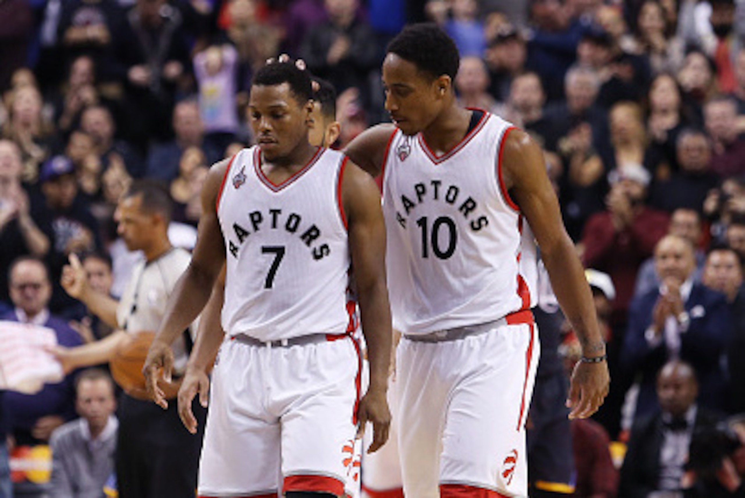 TORONTO, ON - DECEMBER 05:  DeMar DeRozan #10 of the Toronto Raptors consoles Kyle Lowry #7 during an NBA game against the Golden State Warriors at the Air Canada Centre on December 05, 2015 in Toronto, Ontario, Canada.  NOTE TO USER: User expressly ackno