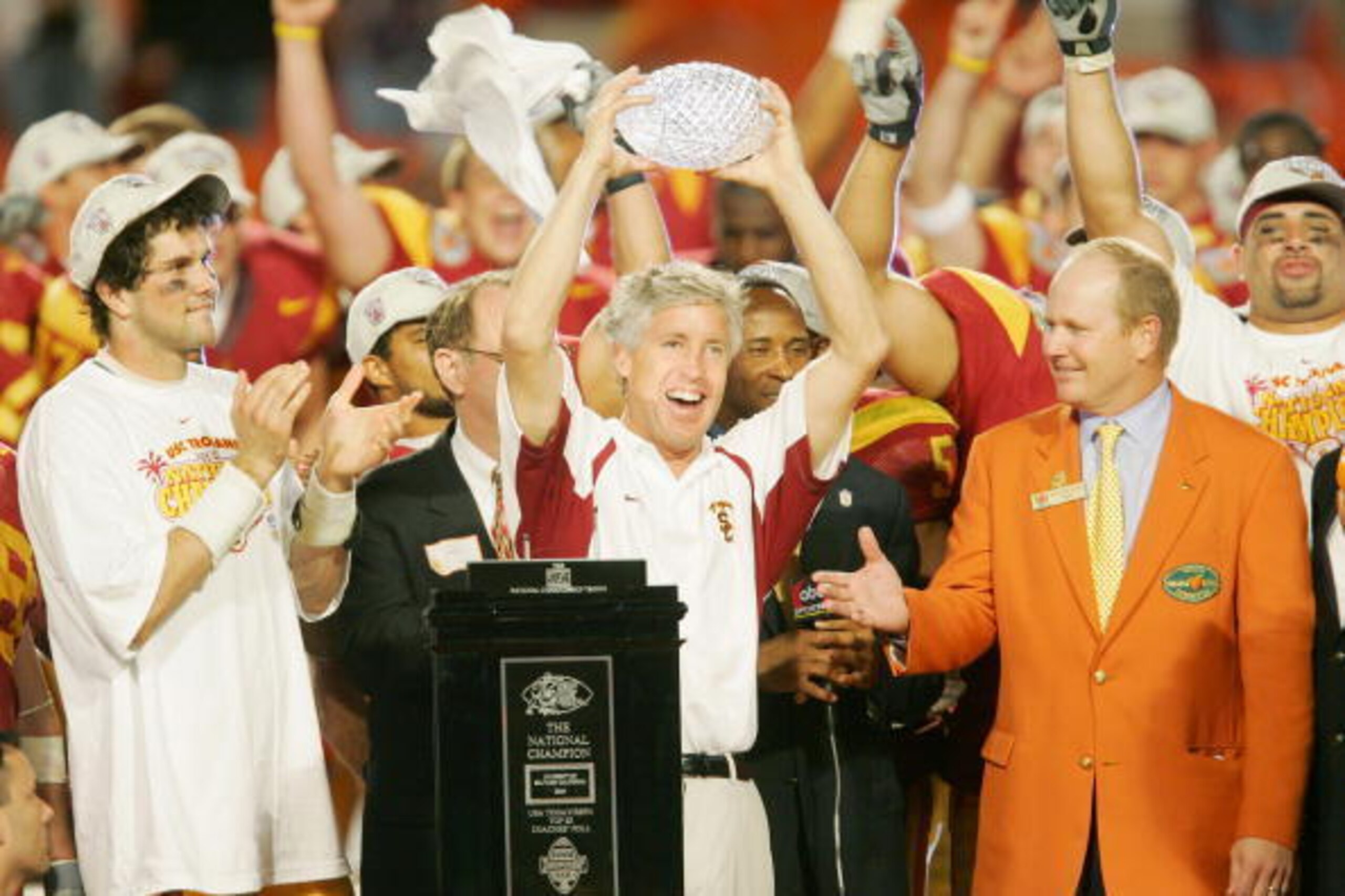 MIAMI - JANUARY 4:  Head coach Pete Carroll (C) and quarterback Matt Leinart #11 (L) of the USC Trojans celebrate with the championship trophy after defeating the Oklahoma Sooners 55-19 to win the FedEx Orange Bowl 2005 National Championship on January 4,