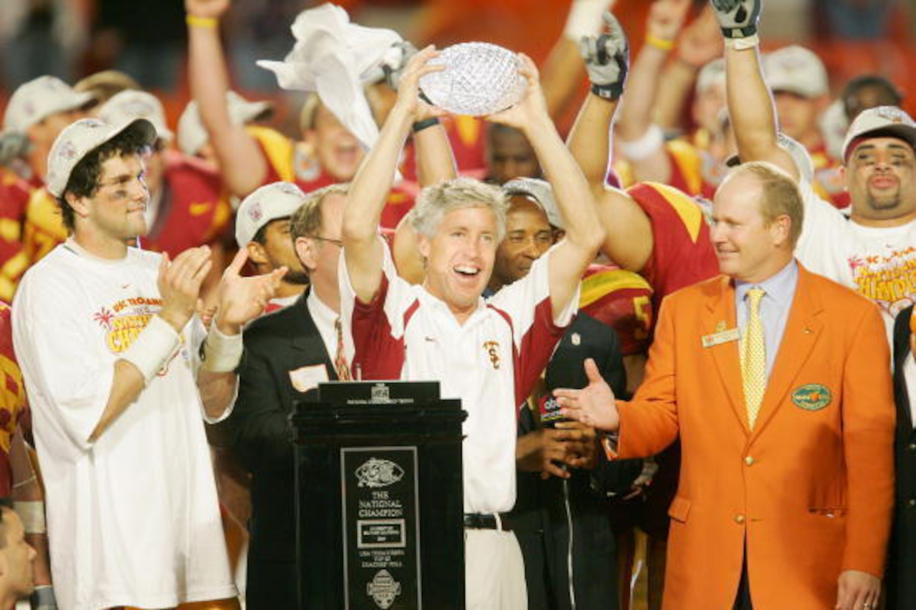 MIAMI - JANUARY 4:  Head coach Pete Carroll (C) and quarterback Matt Leinart #11 (L) of the USC Trojans celebrate with the championship trophy after defeating the Oklahoma Sooners 55-19 to win the FedEx Orange Bowl 2005 National Championship on January 4,