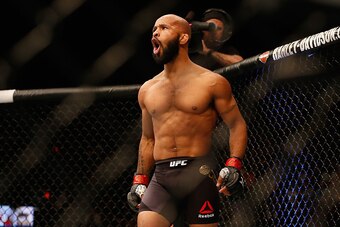 LAS VEGAS, NV - APRIL 23:  Demetrious Johnson celebrates his TKO victory over Henry Cejudo in their flyweight championship bout during the UFC 197 event inside MGM Grand Garden Arena on April 23, 2016 in Las Vegas, Nevada.  (Photo by Christian Petersen/Zu