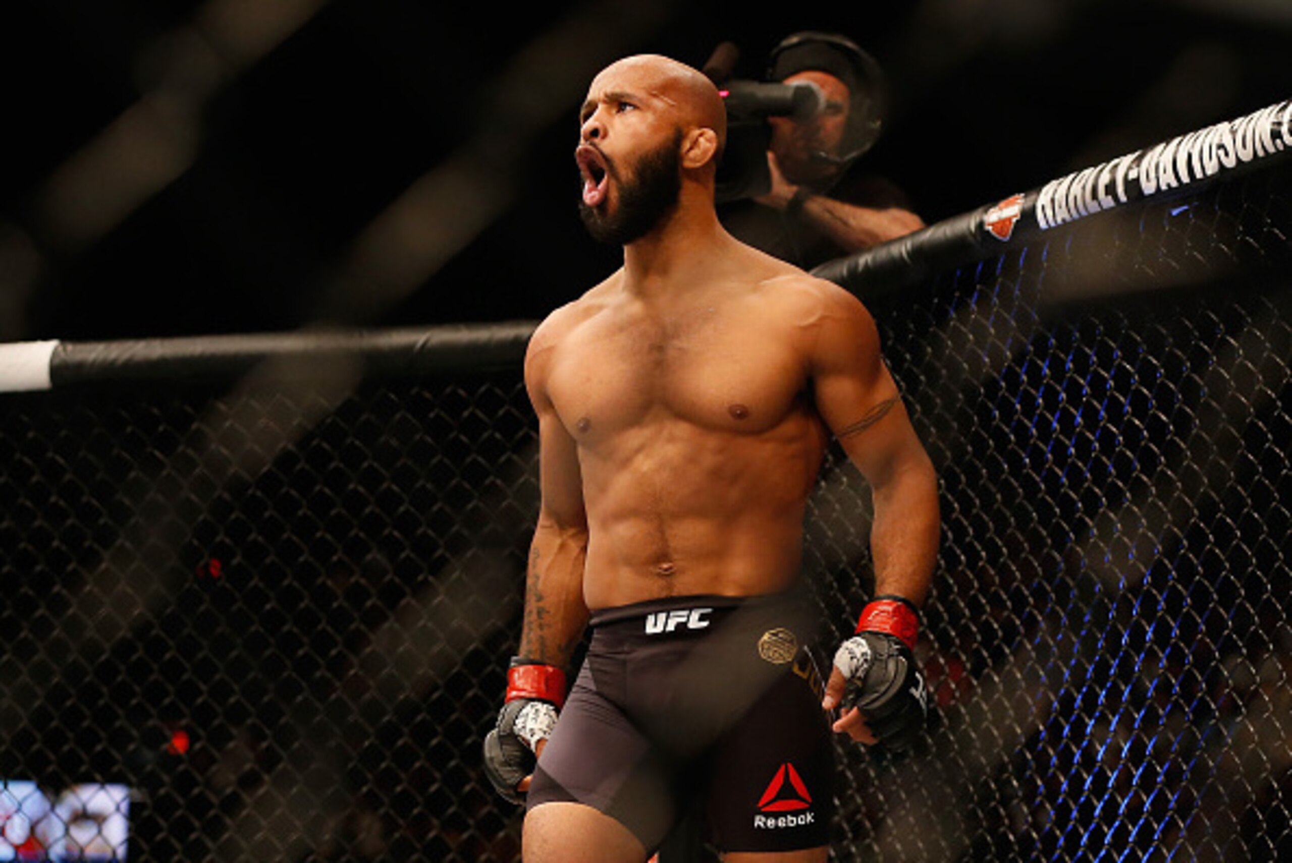 LAS VEGAS, NV - APRIL 23:  Demetrious Johnson celebrates his TKO victory over Henry Cejudo in their flyweight championship bout during the UFC 197 event inside MGM Grand Garden Arena on April 23, 2016 in Las Vegas, Nevada.  (Photo by Christian Petersen/Zu