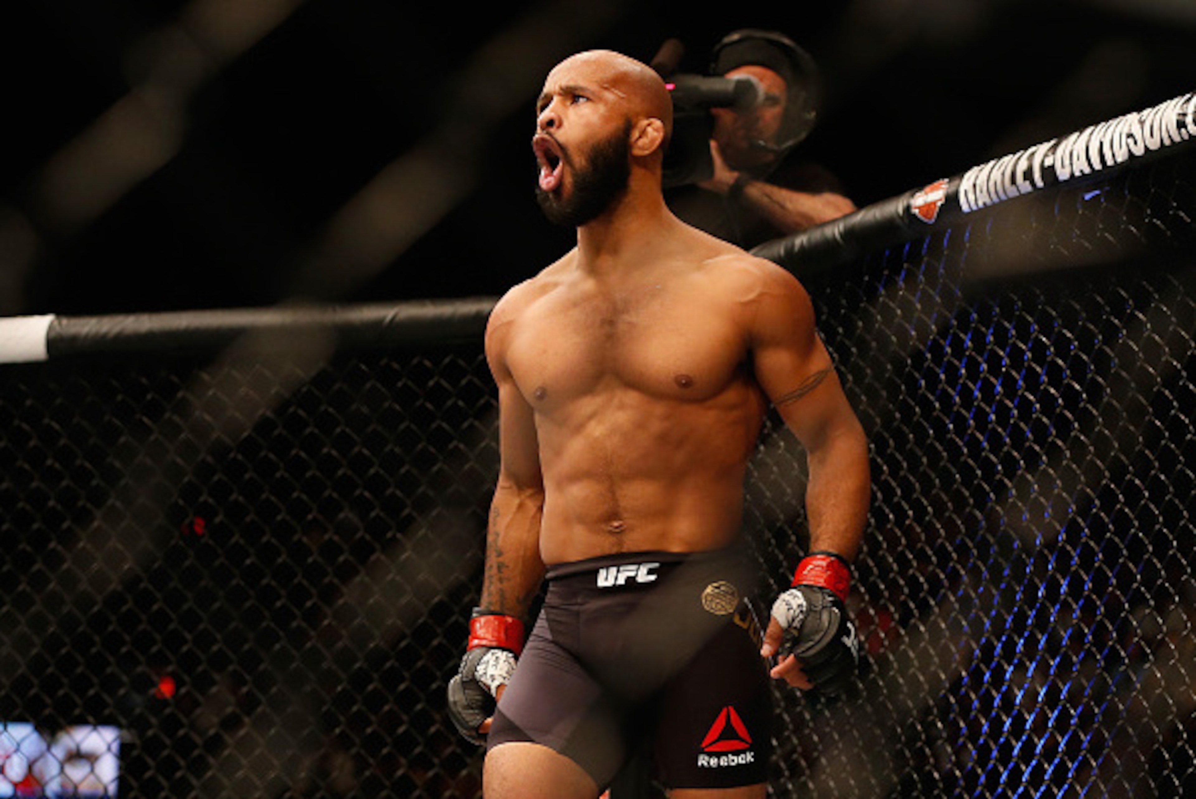 LAS VEGAS, NV - APRIL 23:  Demetrious Johnson celebrates his TKO victory over Henry Cejudo in their flyweight championship bout during the UFC 197 event inside MGM Grand Garden Arena on April 23, 2016 in Las Vegas, Nevada.  (Photo by Christian Petersen/Zu