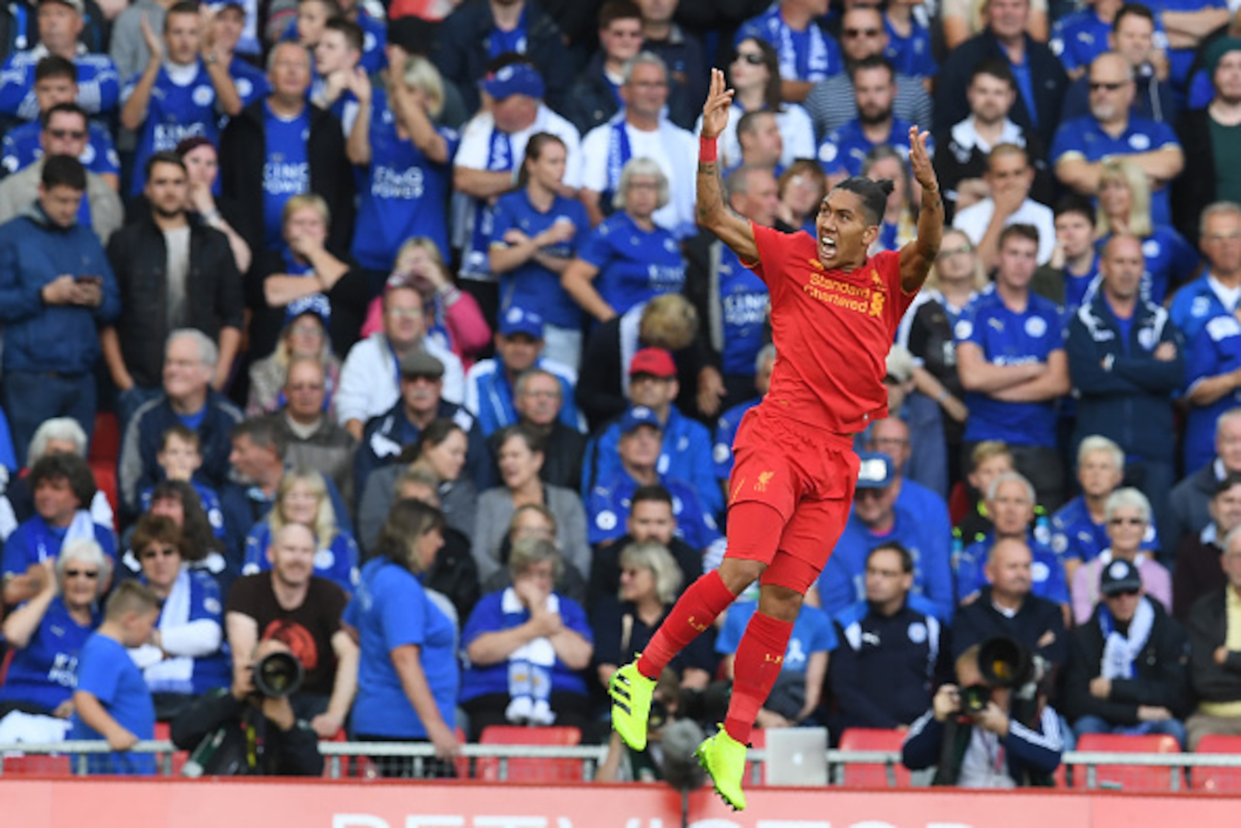 Liverpool's Brazilian midfielder Roberto Firmino celebrates after scoring the opening goal of the English Premier League football match between Liverpool and Leicester City at Anfield in Liverpool, north west England on September 10, 2016. / AFP / Paul EL