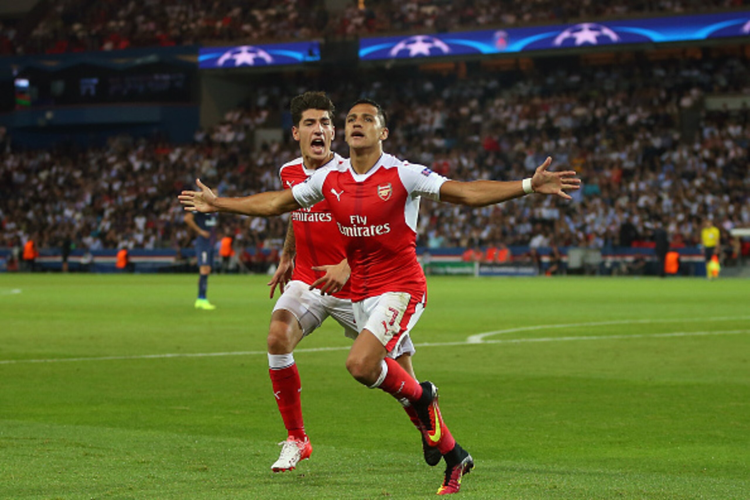 PARIS, FRANCE - SEPTEMBER 13: Alexis Sanchez of Arsenal celebrates after he scores to make it 1-1 with Hector Bellerin of Arsenal during the UEFA Champions League match between Paris Saint-Germain and Arsenal at Parc des Princes on September 13, 2016 in P