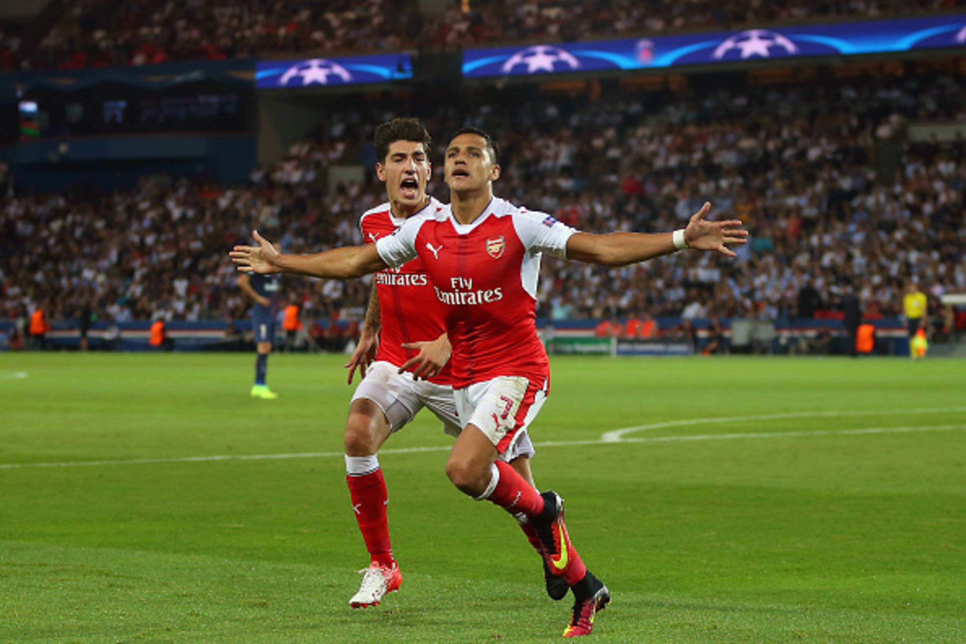PARIS, FRANCE - SEPTEMBER 13: Alexis Sanchez of Arsenal celebrates after he scores to make it 1-1 with Hector Bellerin of Arsenal during the UEFA Champions League match between Paris Saint-Germain and Arsenal at Parc des Princes on September 13, 2016 in P