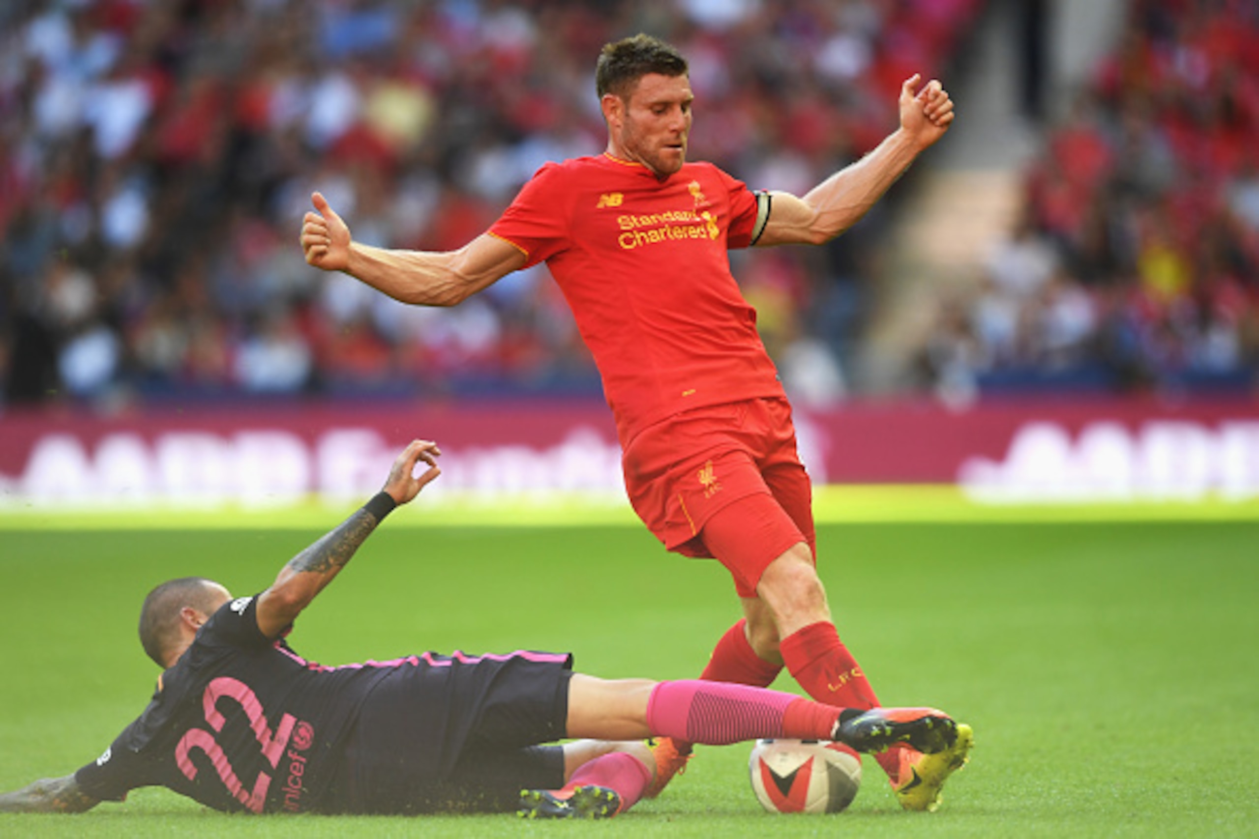LONDON, ENGLAND - AUGUST 06:  James Milner of Liverpool is tackled by Aleix Vidal of Barcelona during the International Champions Cup match between Liverpool and Barcelona at Wembley Stadium on August 6, 2016 in London, England.  (Photo by Michael Regan/G