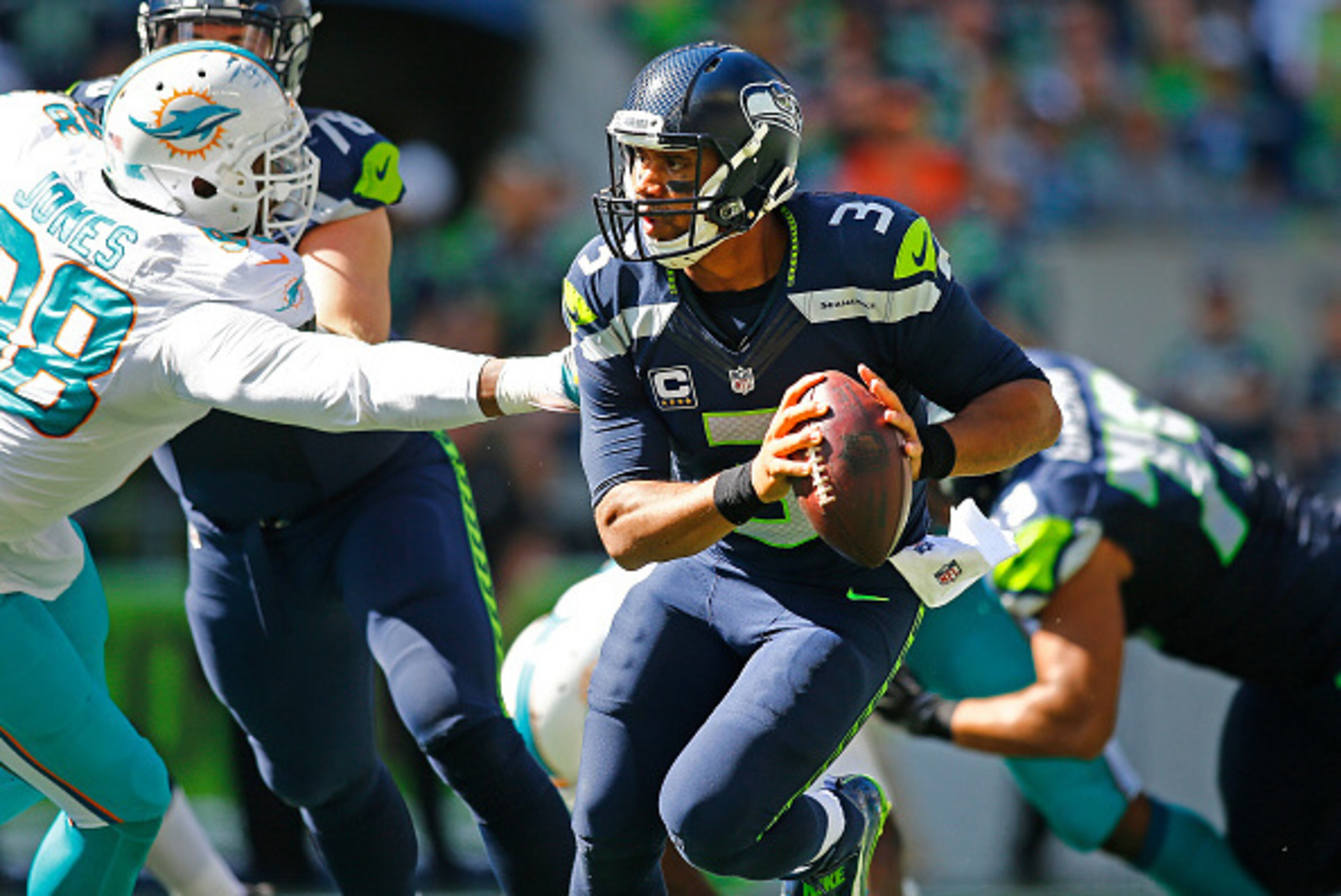SEATTLE, WA - SEPTEMBER 11: Quarterback Russell Wilson #3 of the Seattle Seahawks tries to evade the Miami Dolphins defense in the first half at CenturyLink Field on September 11, 2016 in Seattle, Washington. (Photo by Jonathan Ferrey/Getty Images) SEATTLE, WA - SEPTEMBER 11: Quarterback Russell Wilson #3 of the Seattle Seahawks tries to evade the Miami Dolphins defense in the first half at CenturyLink Field on September 11, 2016 in Seattle, Washington. (Photo by Jonathan Ferrey/Getty Images)
