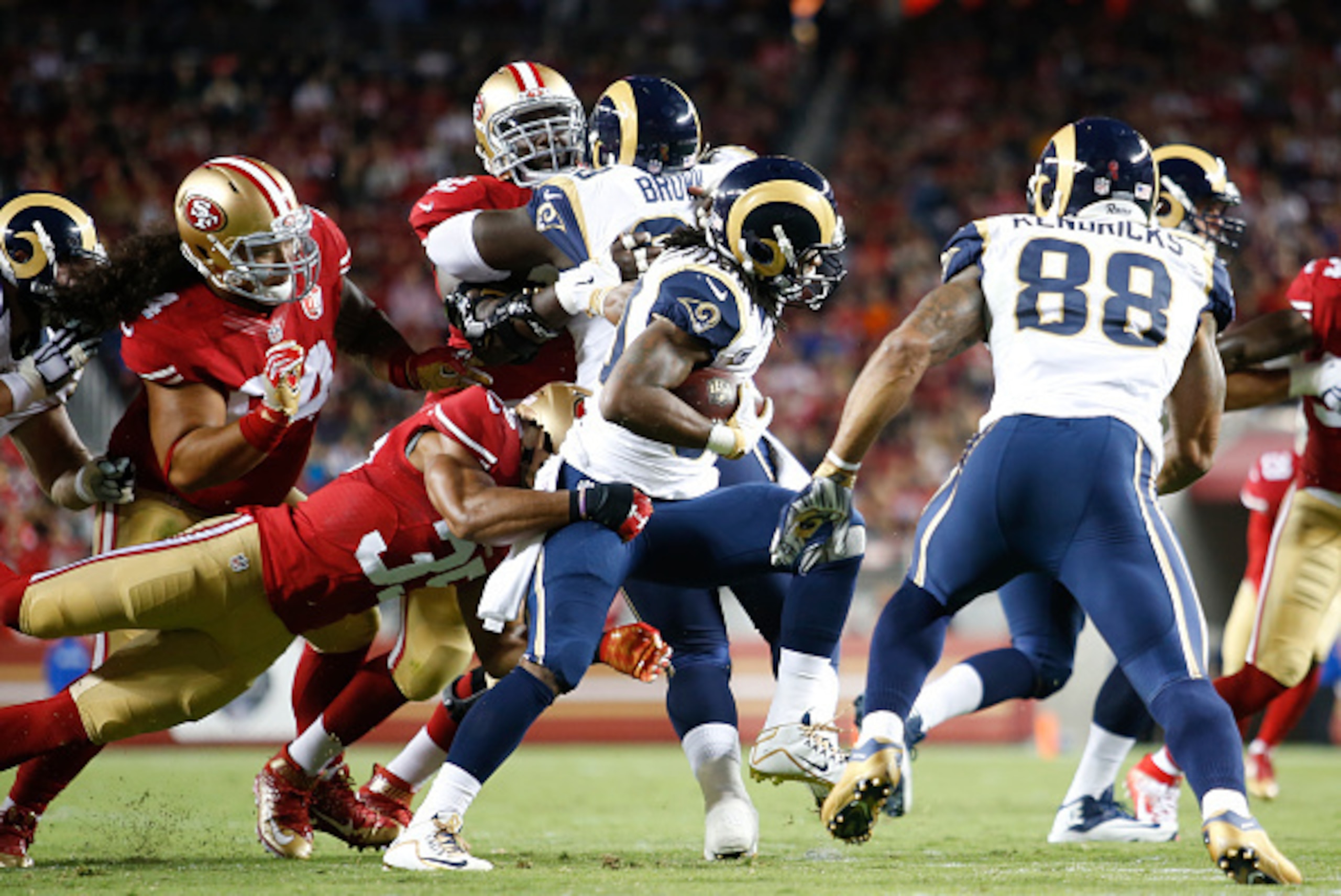 SANTA CLARA, CA - SEPTEMBER 12: Eric Reid #35 of the San Francisco 49ers tackles Todd Gurley #30 of the Los Angeles Rams during the game at Levi Stadium on September 12, 2016 in Santa Clara, California. The 49ers defeated the Rams 28-0. (Photo by Michael 