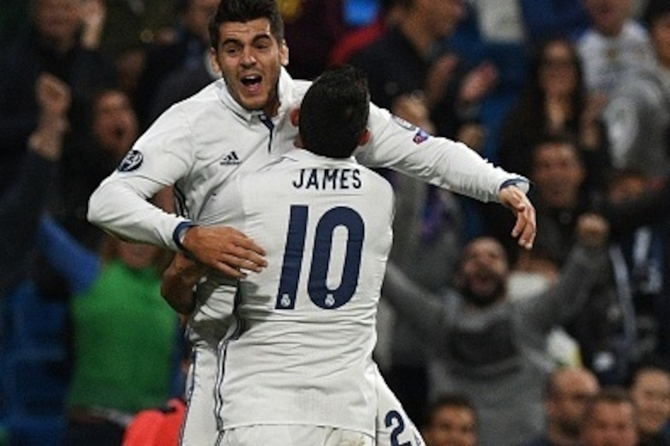 Real Madrid's forward Alvaro Morata (back) is congratulated by Real Madrid's Colombian midfielder James Rodriguez after scoring during the UEFA Champions League football match Real Madrid CF vs Sporting CP at the Santiago Bernabeu stadium in Madrid on Sep