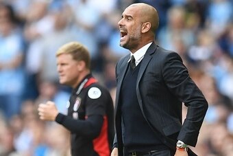 Manchester City's Spanish manager Pep Guardiola (R) gestures on the touchline next to Bournemouth's English manager Eddie Howe (L) during the English Premier League football match between Manchester City and Bournemouth at the Etihad Stadium in Manchester