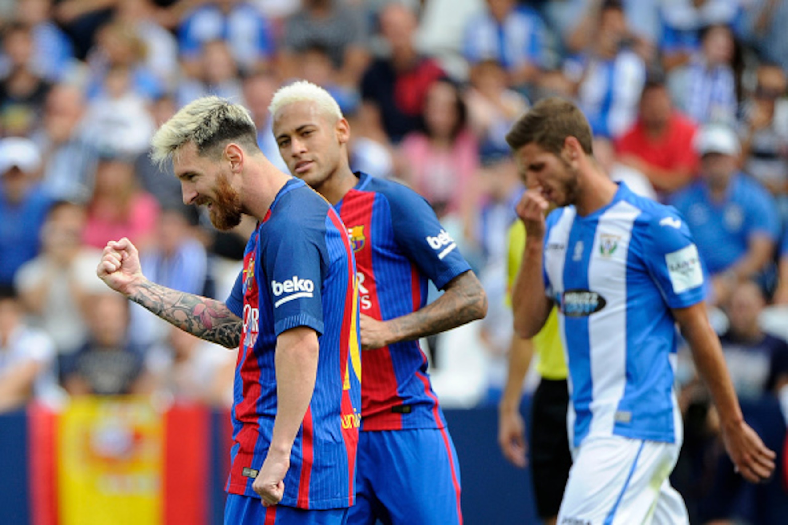 Barcelona's Argentinian forward Lionel Messi (L) celebrates past Barcelona's Brazilian forward Neymar after scoring a penalty during the Spanish league football match CD Leganes CF vs FC Barcelona at the Butarque municipal stadium in Leganes on September 