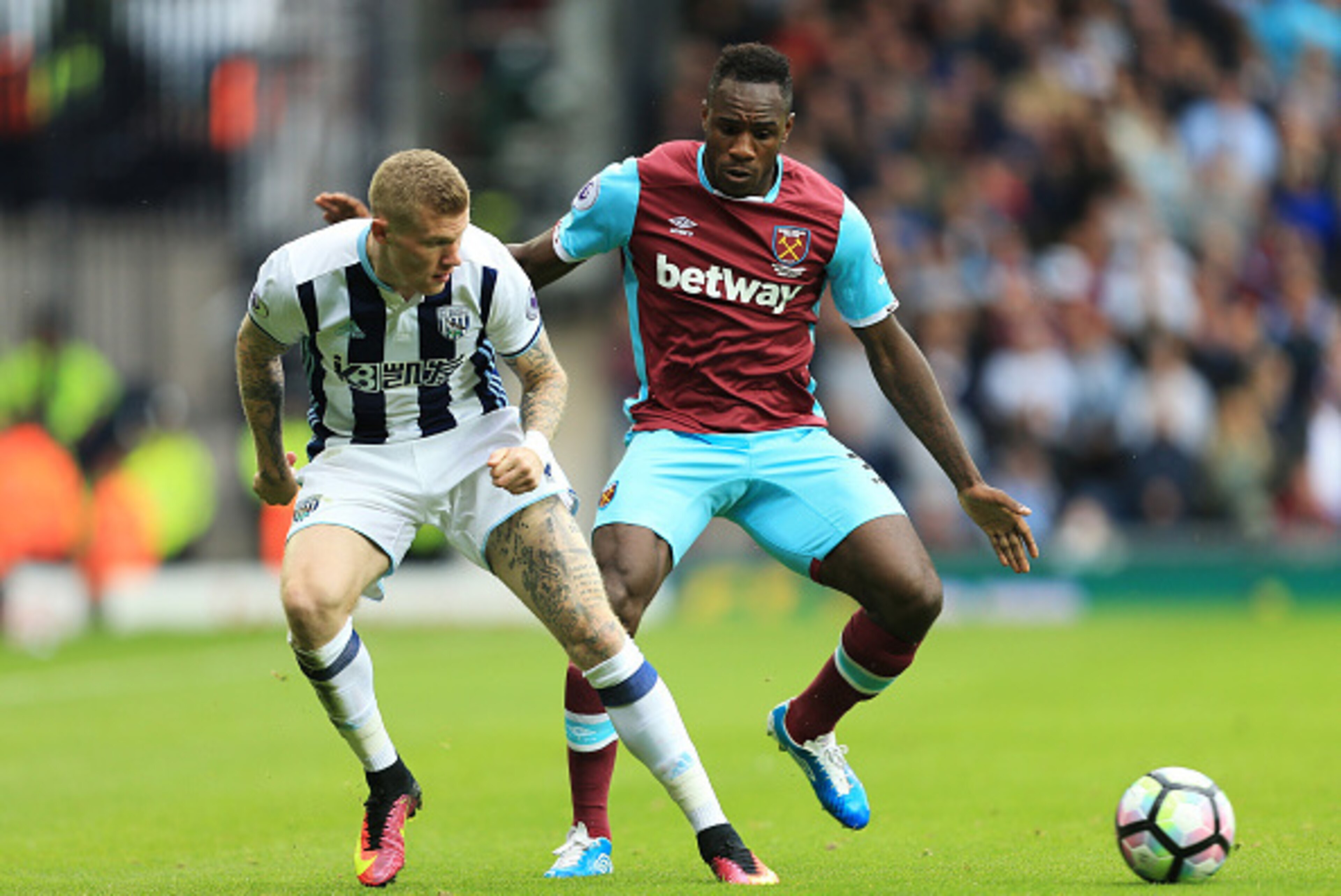 WEST BROMWICH, ENGLAND - SEPTEMBER 17:  James McClean of West Bromwich AlbJames McClean of West Bromwich Albion(L) and Michail Antonio of West Ham UniMichail Antonio of West Ham United(R) battle for possession during the Premier League match between West 