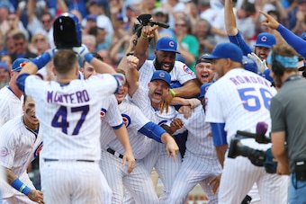 Sep 16, 2016; Chicago, IL, USA; Chicago Cubs catcher Miguel Montero (47) is greeted by teammates at home plate after hitting a walk off home run in the 10th inning against the Milwaukee Brewers at Wrigley Field. The Cubs clinched the National League Centr
