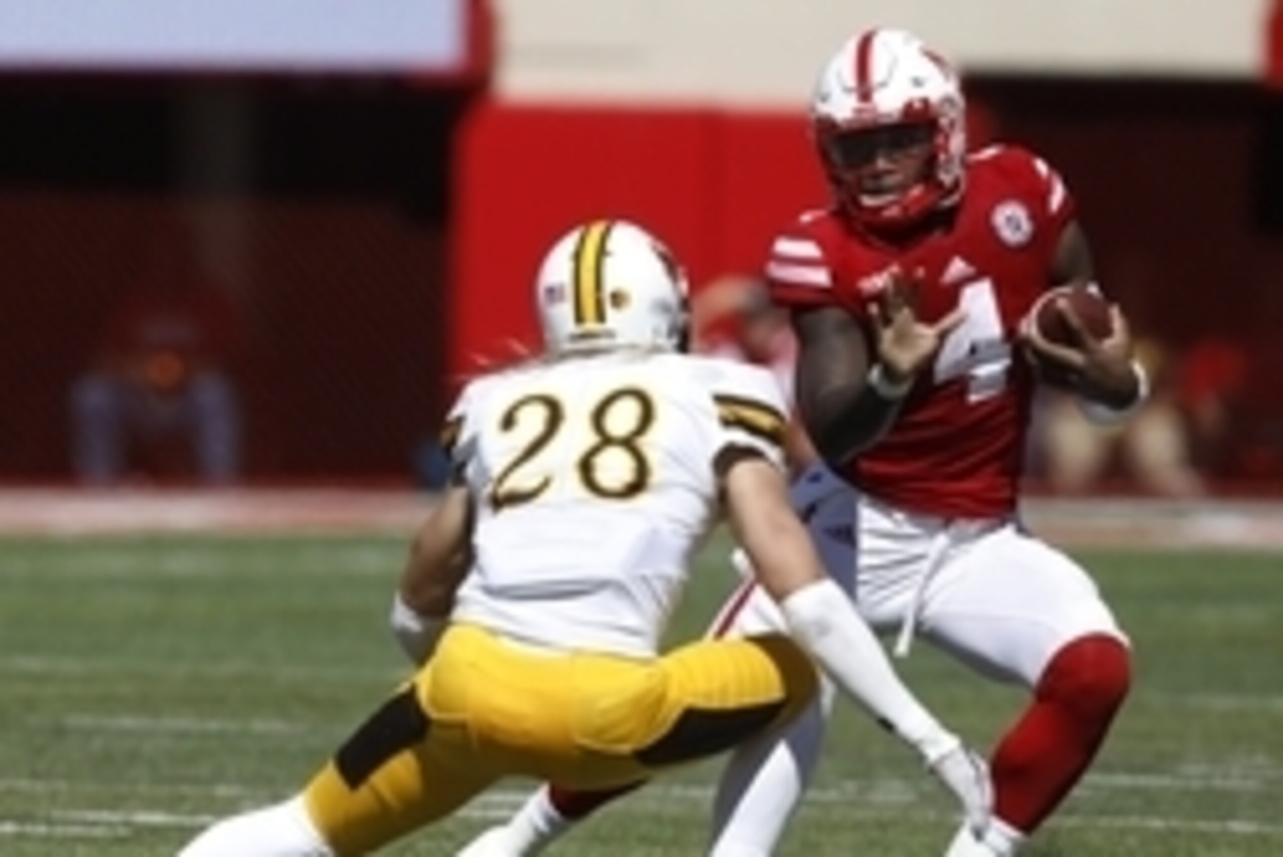Sep 10, 2016; Lincoln, NE, USA; Nebraska Cornhuskers quarterback Tommy Armstrong (4) runs against Wyoming Cowboys safety Andrew Winged (28) in the second quarter at Memorial Stadium. Mandatory Credit: Bruce Thorson-USA TODAY Sports