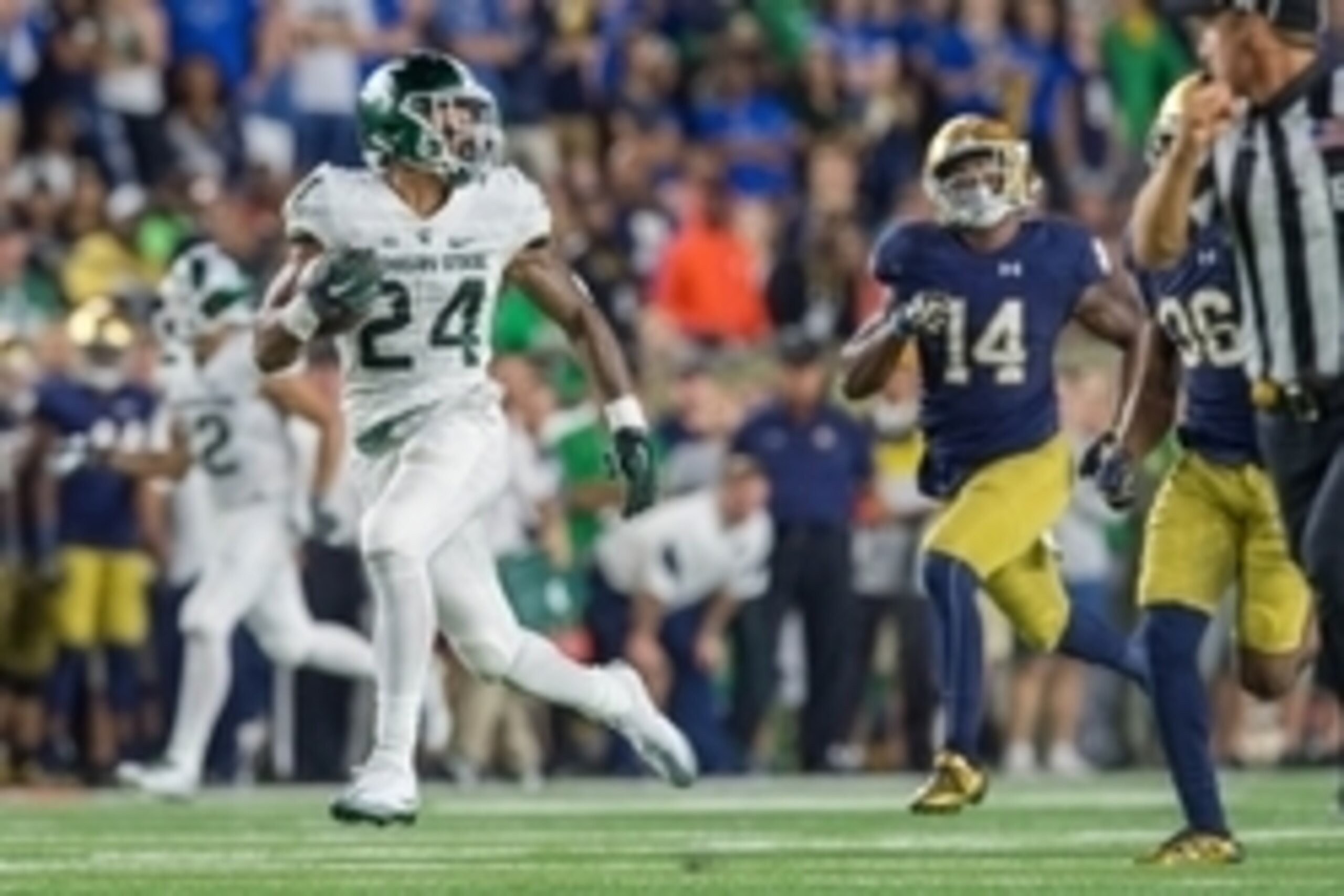 Sep 17, 2016; South Bend, IN, USA; Michigan State Spartans running back Gerald Holmes (24) runs for a touchdown as Notre Dame Fighting Irish safety Devin Studstill (14) pursues in the third quarter at Notre Dame Stadium. MSU won 36-28. Mandatory Credit: M