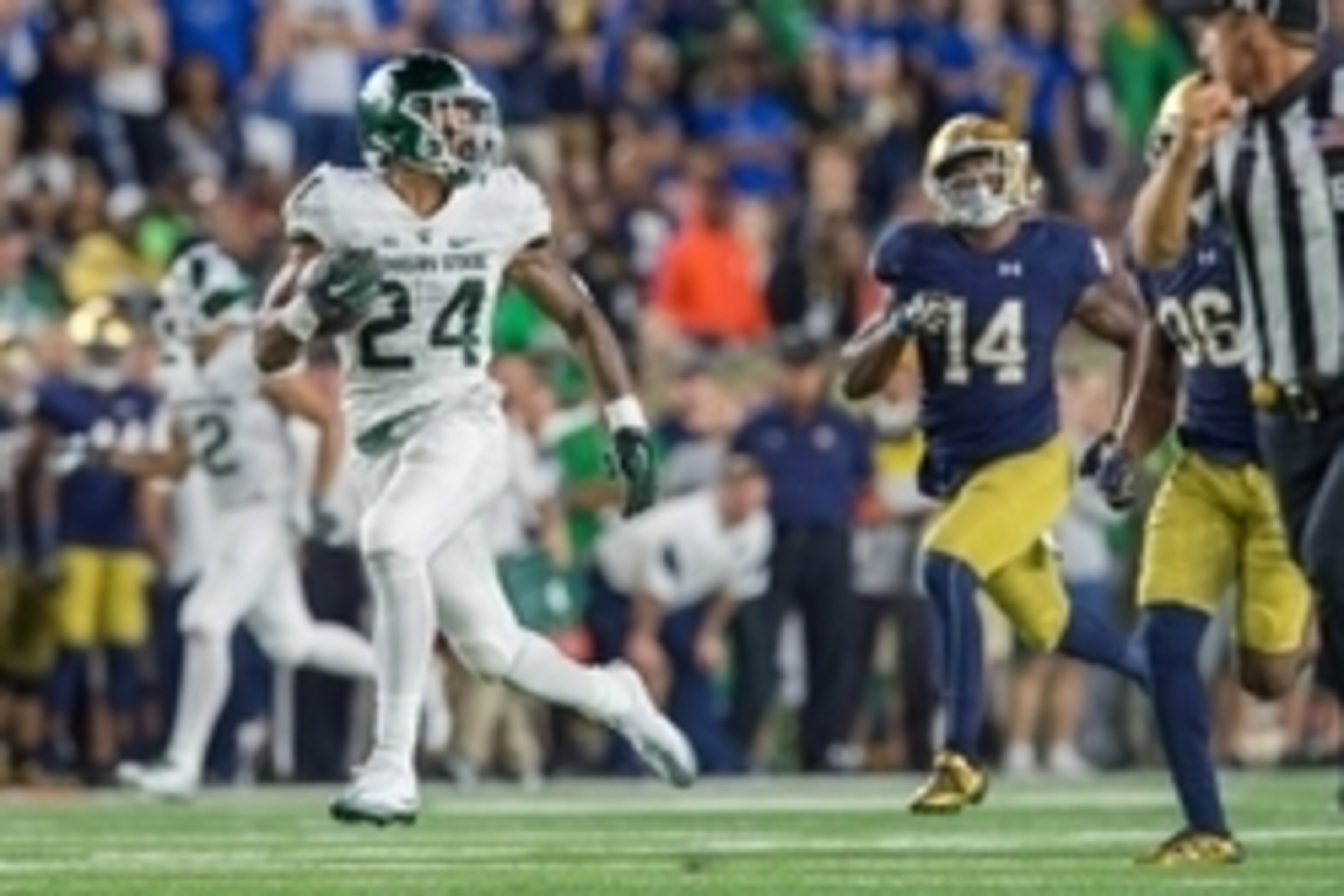 Sep 17, 2016; South Bend, IN, USA; Michigan State Spartans running back Gerald Holmes (24) runs for a touchdown as Notre Dame Fighting Irish safety Devin Studstill (14) pursues in the third quarter at Notre Dame Stadium. MSU won 36-28. Mandatory Credit: M