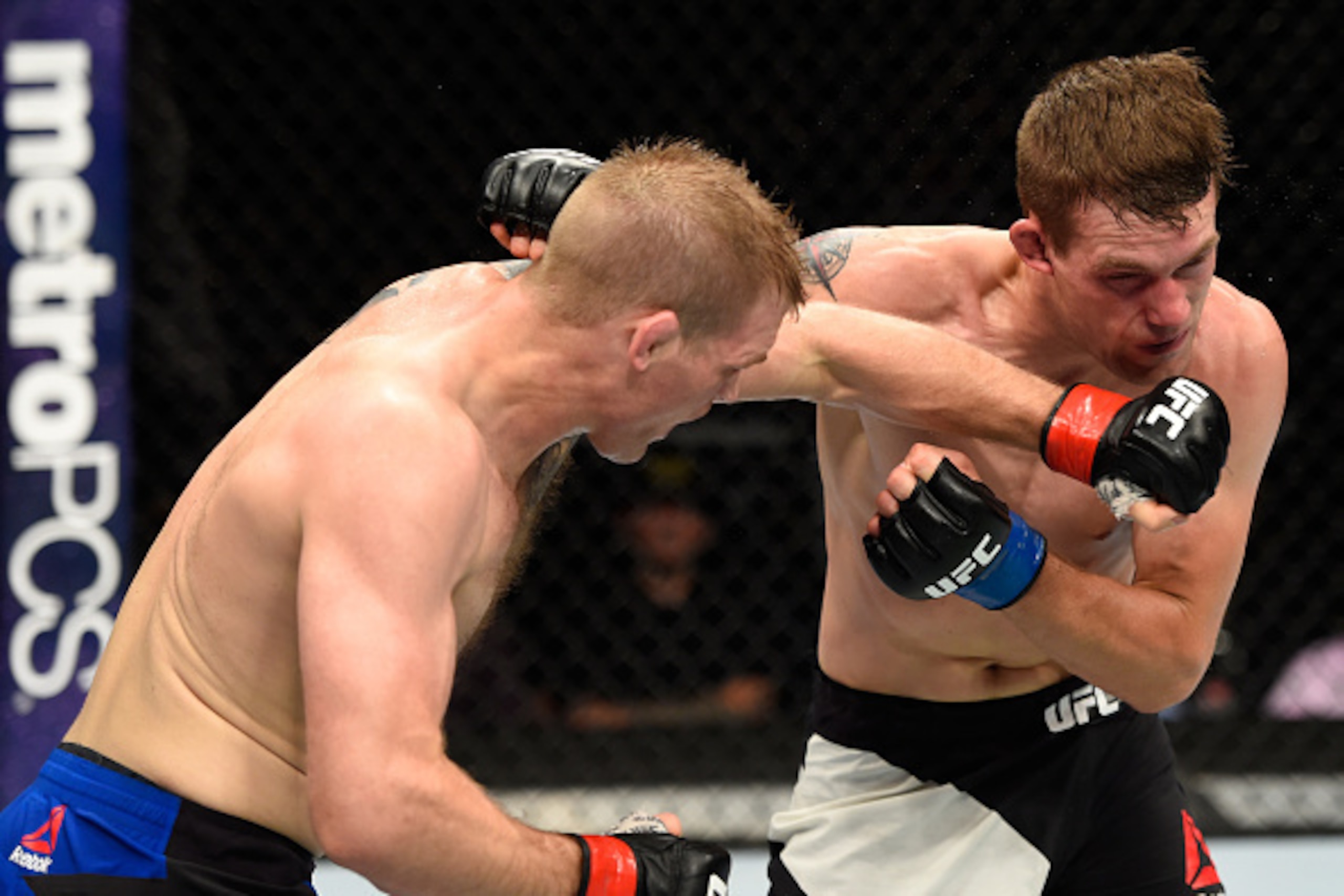 HIDALGO, TX - SEPTEMBER 17:   (L-R) Evan Dunham punches Rick Glenn in their lightweight bout during the UFC Fight Night event at State Farm Arena on September 17, 2016 in Hidalgo, Texas. (Photo by Josh Hedges/Zuffa LLC/Zuffa LLC via Getty Images)