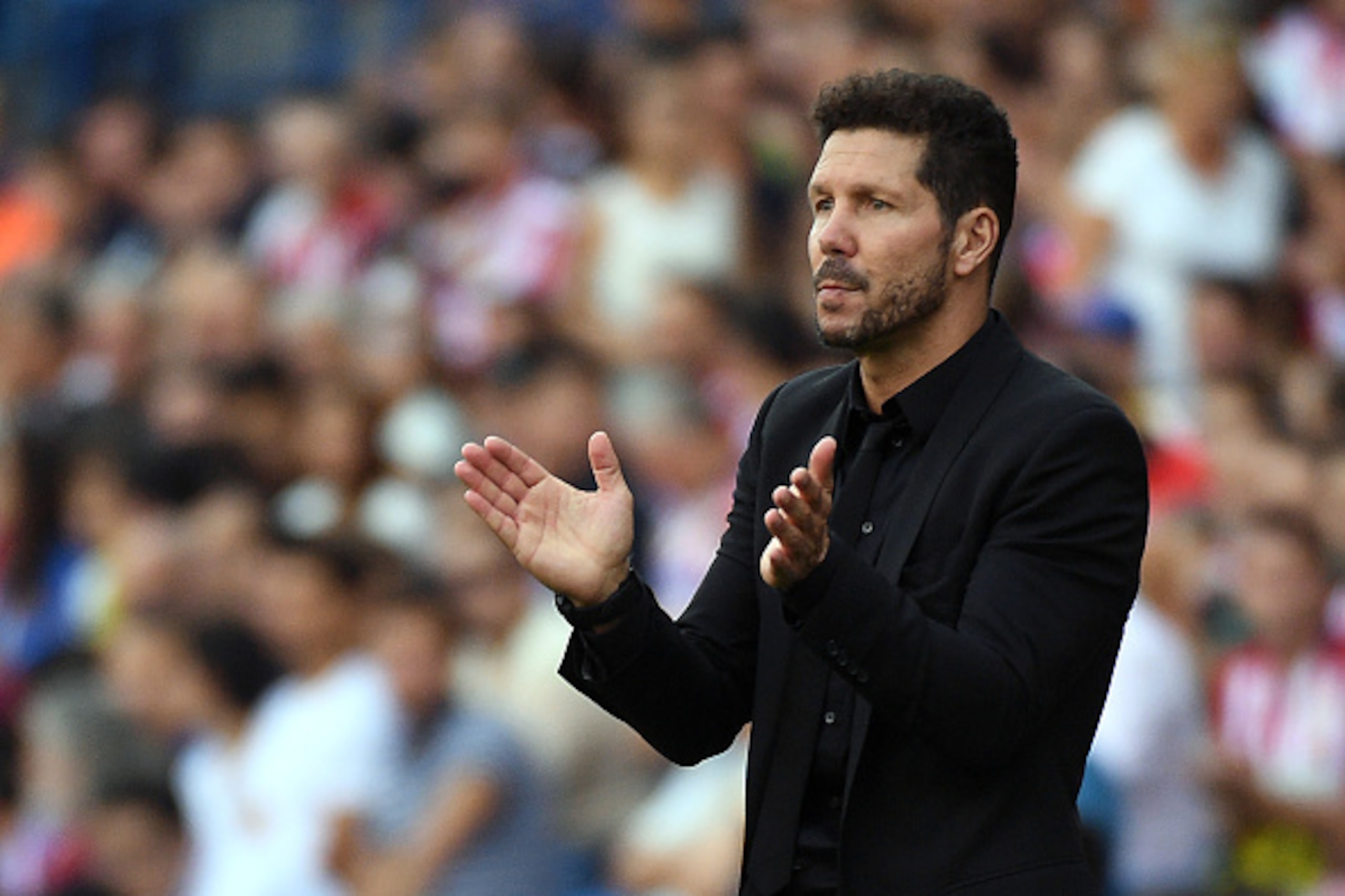 Atletico Madrid's Argentinian coach Diego Simeone applauds during the Spanish league football match Club Atletico de Madrid vs Real Sporting de Gijon at the Vicente Calderon stadium in Madrid on September 17, 2016. / AFP / GERARD JULIEN        (Photo cred