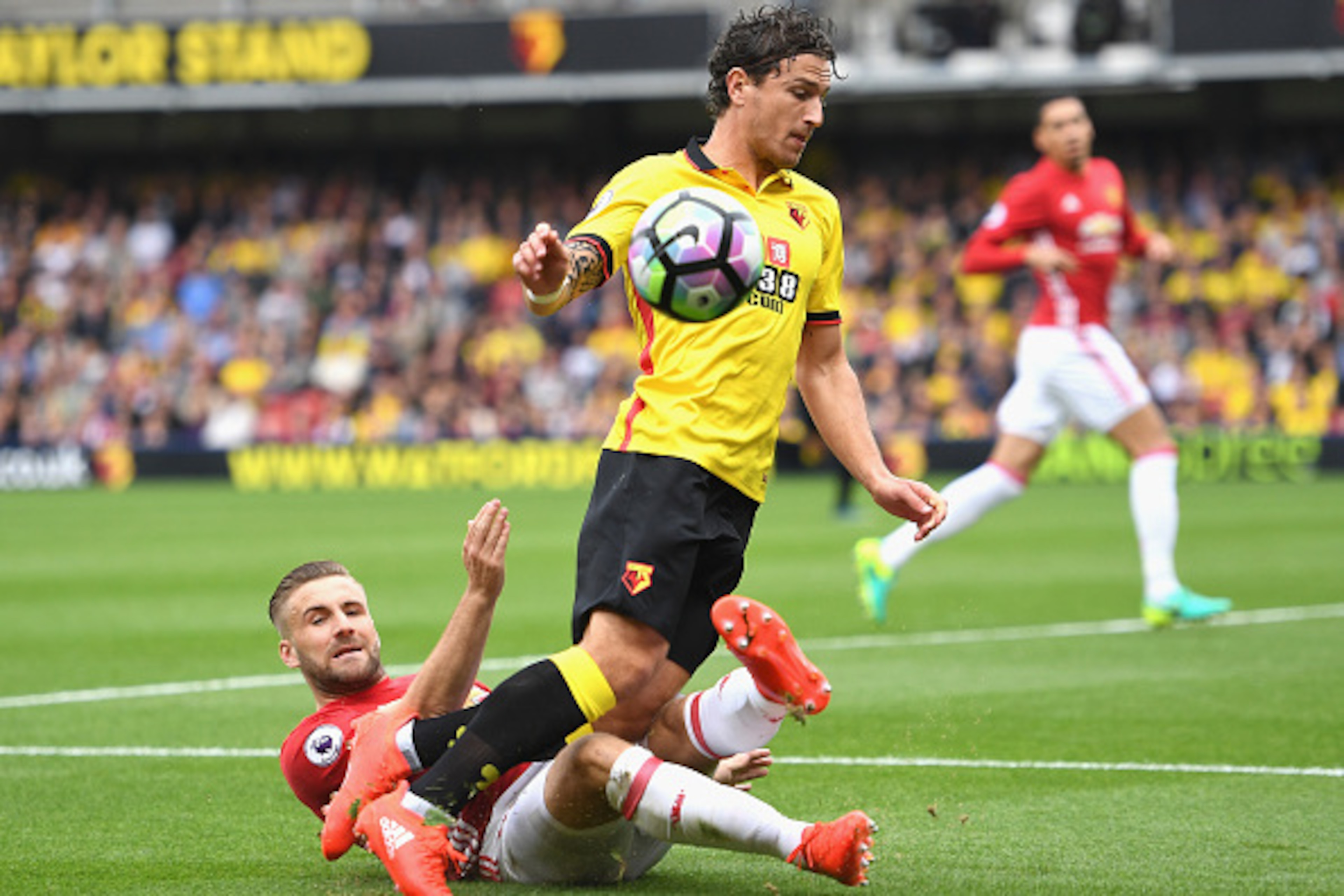 WATFORD, ENGLAND - SEPTEMBER 18: Luke Shaw of Manchester United (L) tackles Daryl Janmaat of Watford (R) during the Premier League match between Watford and Manchester United at Vicarage Road on September 18, 2016 in Watford, England.  (Photo by Laurence 