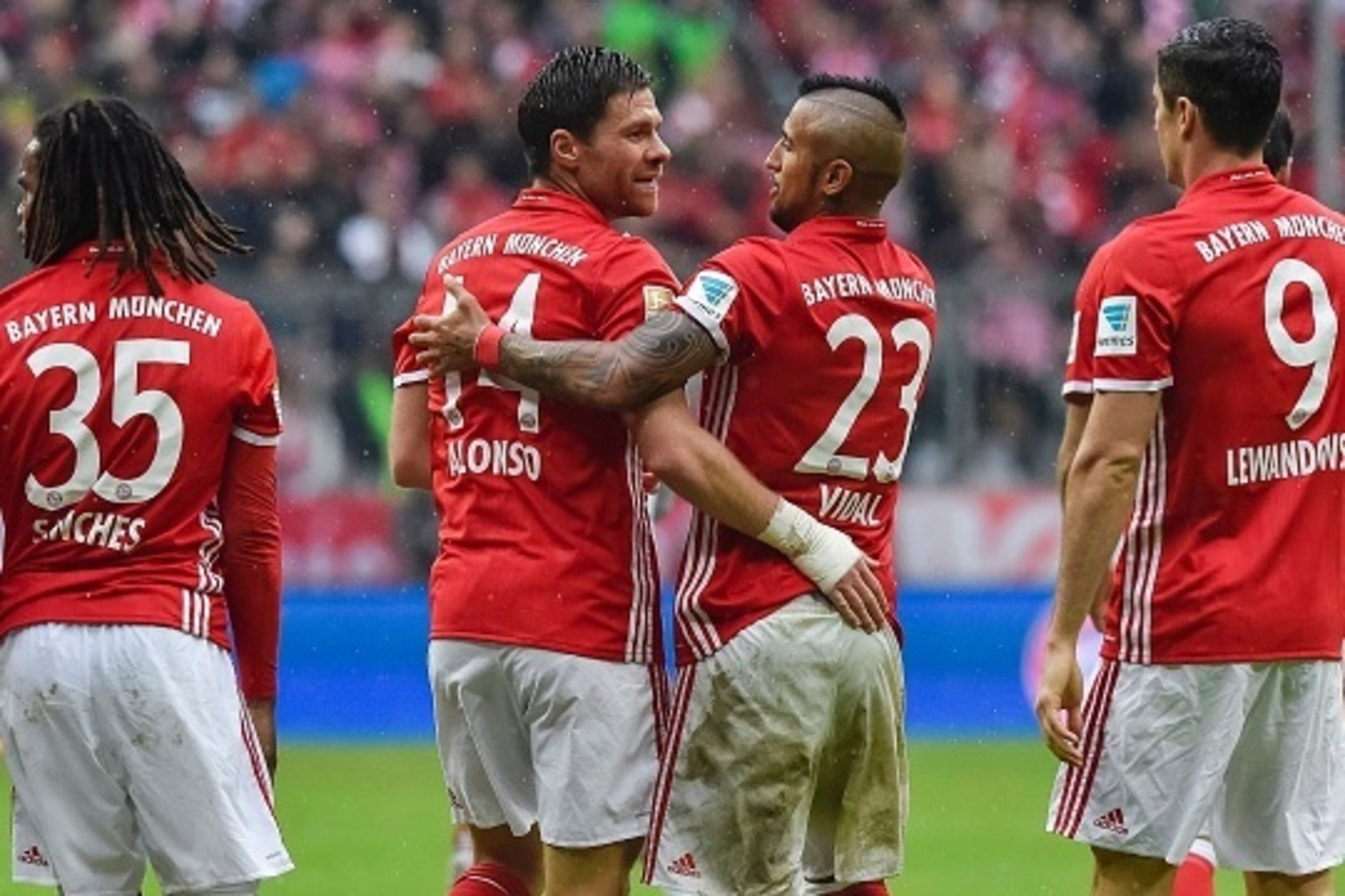 Bayern Munich's Spanish midfielder Xabi Alonso (2nd L) celebrates with his teammate Bayern Munich's Chilean midfielder Arturo Vidal (C-R) after scoring during the German first division Bundesliga football match of Bayern Munich vs FC Ingolstadt in Munich, Bayern Munich's Spanish midfielder Xabi Alonso (2nd L) celebrates with his teammate Bayern Munich's Chilean midfielder Arturo Vidal (C-R) after scoring during the German first division Bundesliga football match of Bayern Munich vs FC Ingolstadt in Munich,