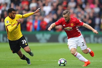 WATFORD, ENGLAND - SEPTEMBER 18: Luke Shaw of Manchester United (R) takes the ball past Etienne Capoue of Watford (L)  during the Premier League match between Watford and Manchester United at Vicarage Road on September 18, 2016 in Watford, England.  (Phot