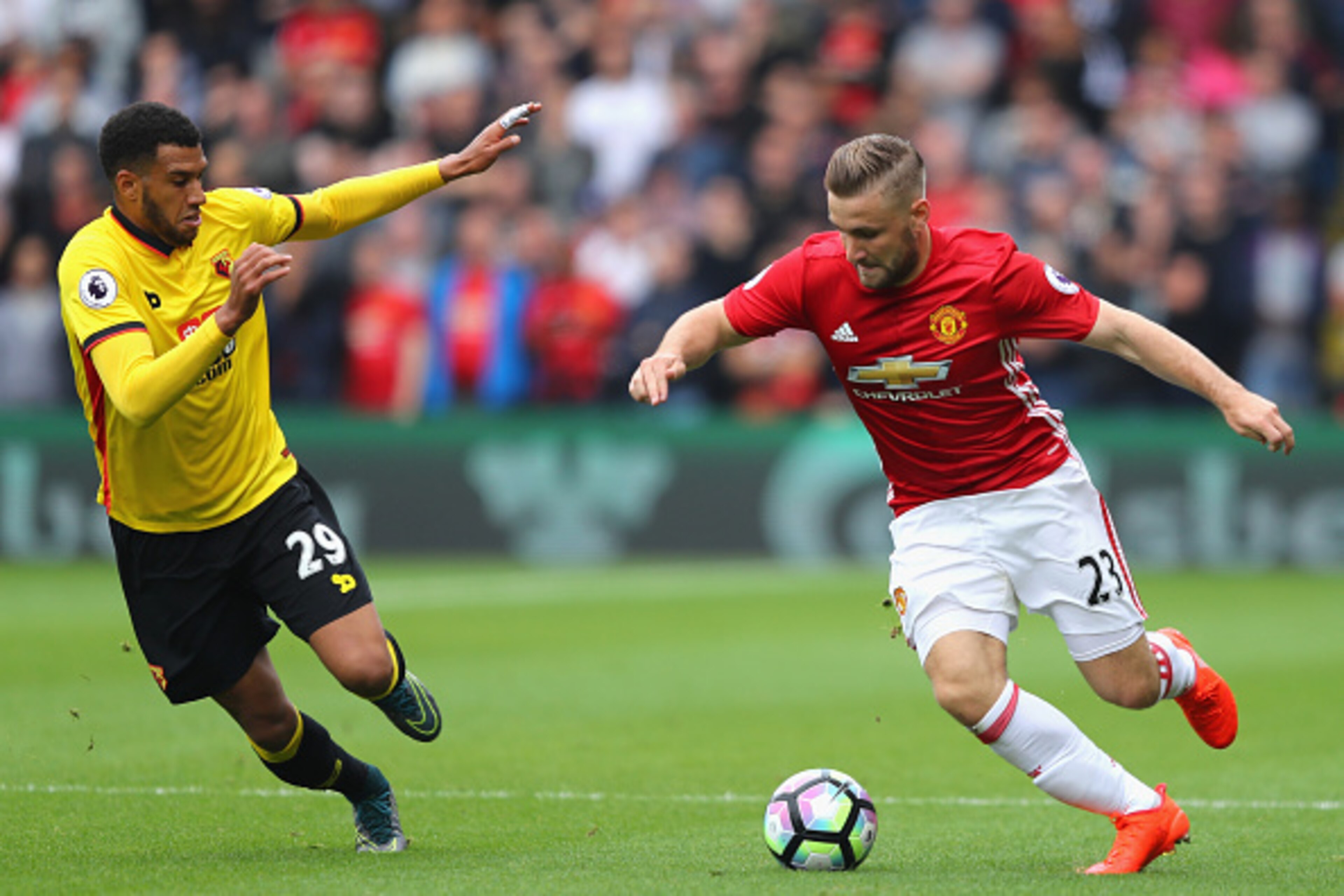 WATFORD, ENGLAND - SEPTEMBER 18: Luke Shaw of Manchester United (R) takes the ball past Etienne Capoue of Watford (L)  during the Premier League match between Watford and Manchester United at Vicarage Road on September 18, 2016 in Watford, England.  (Phot