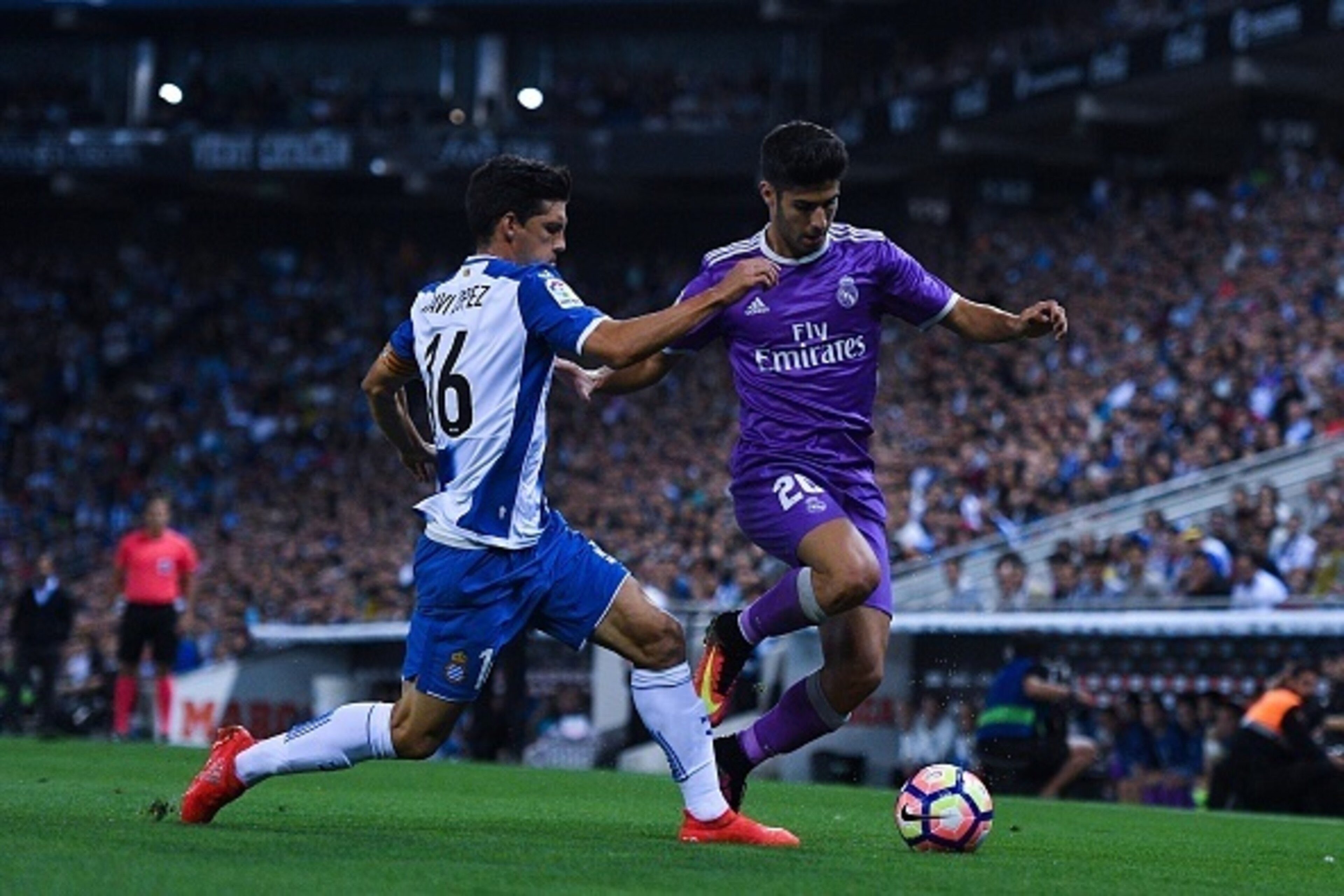 BARCELONA, SPAIN - SEPTEMBER 18:  Javi Lopez of RCD Espanyol competes for the ball with Marco Asensio of Real Madrid CF during the La Liga match between RCD Espanyol and Real Madrid CF at the RCDE stadium on September 18, 2016 in Barcelona, Spain.  (Photo