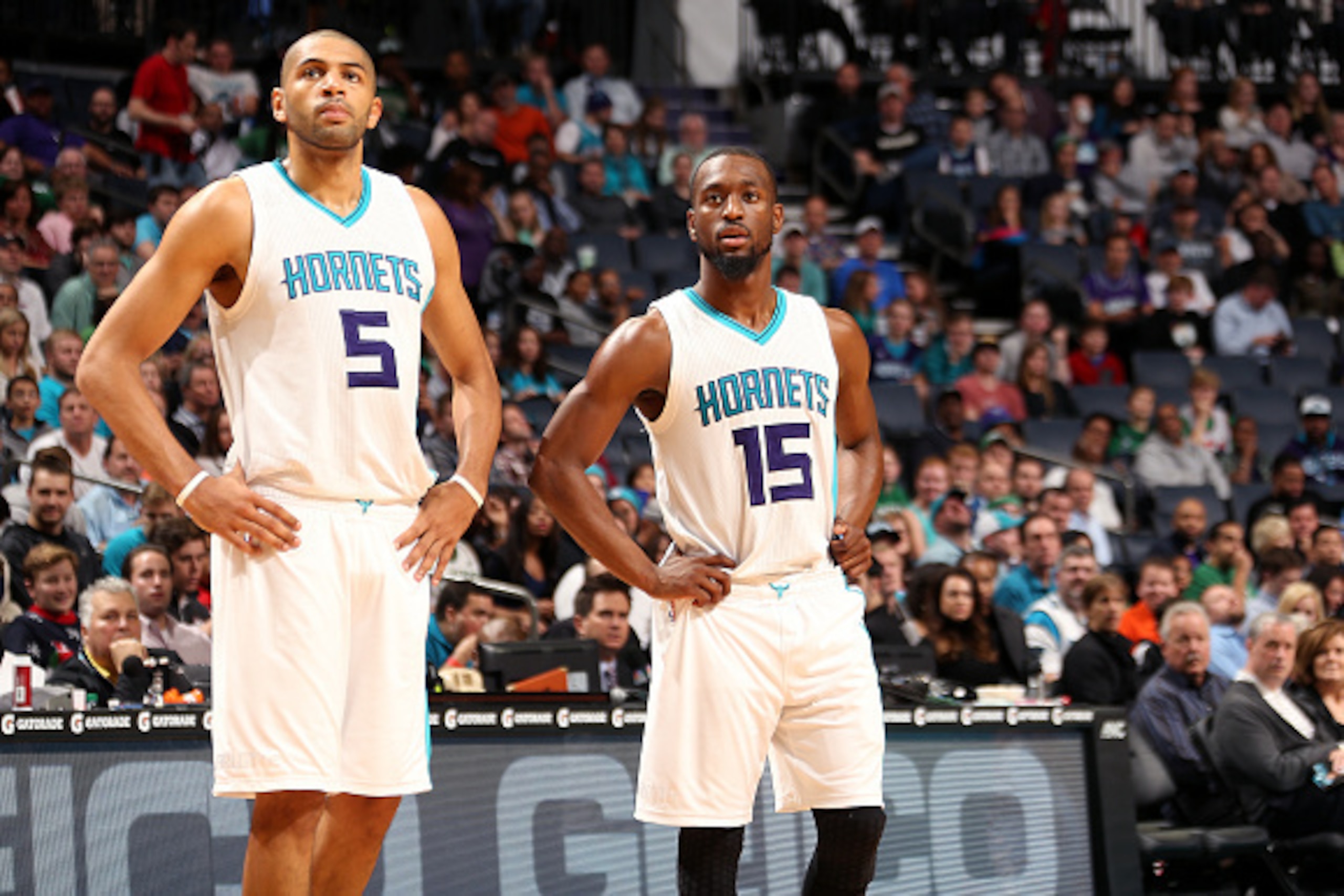 CHARLOTTE, NC - DECEMBER 23: Nicolas Batum #5 and Kemba Walker #15 of the Charlotte Hornets look on during the game against the Boston Celtics on December 23, 2015 at Time Warner Cable Arena in Charlotte, North Carolina. NOTE TO USER: User expressly ackno