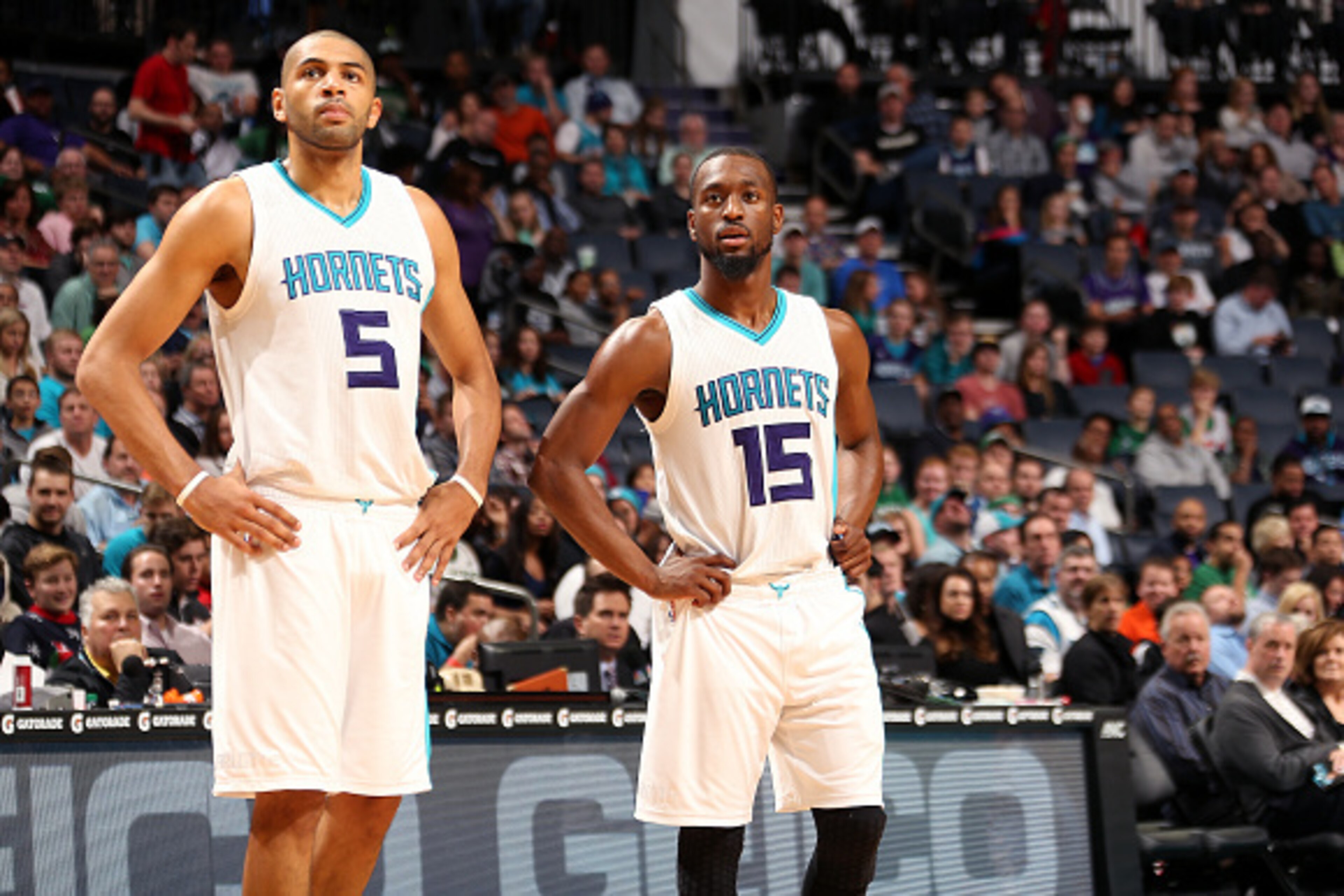 CHARLOTTE, NC - DECEMBER 23: Nicolas Batum #5 and Kemba Walker #15 of the Charlotte Hornets look on during the game against the Boston Celtics on December 23, 2015 at Time Warner Cable Arena in Charlotte, North Carolina. NOTE TO USER: User expressly ackno