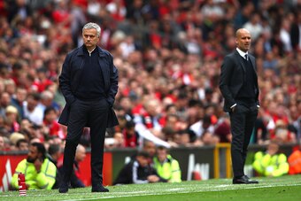MANCHESTER, ENGLAND - SEPTEMBER 10:  Jose Mourinho, Manager of Manchester United (L) and Josep Guardiola, Manager of Manchester City look on during the Premier League match between Manchester United and Manchester City at Old Trafford on September 10, 201