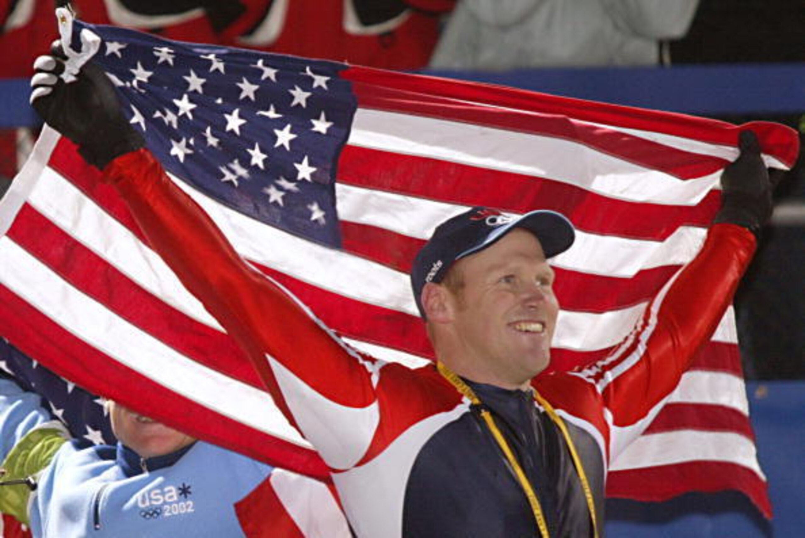 PARK CITY, UNITED STATES:  Brian Shimer the pilot for USA 2  celebrates his team's third place to win the bronze medal  during the flower ceremony for the four-man bobsleigh event  in the Salt Lake 2002 Olympic Winter Games at the Utah Olympic Park, 23 Fe