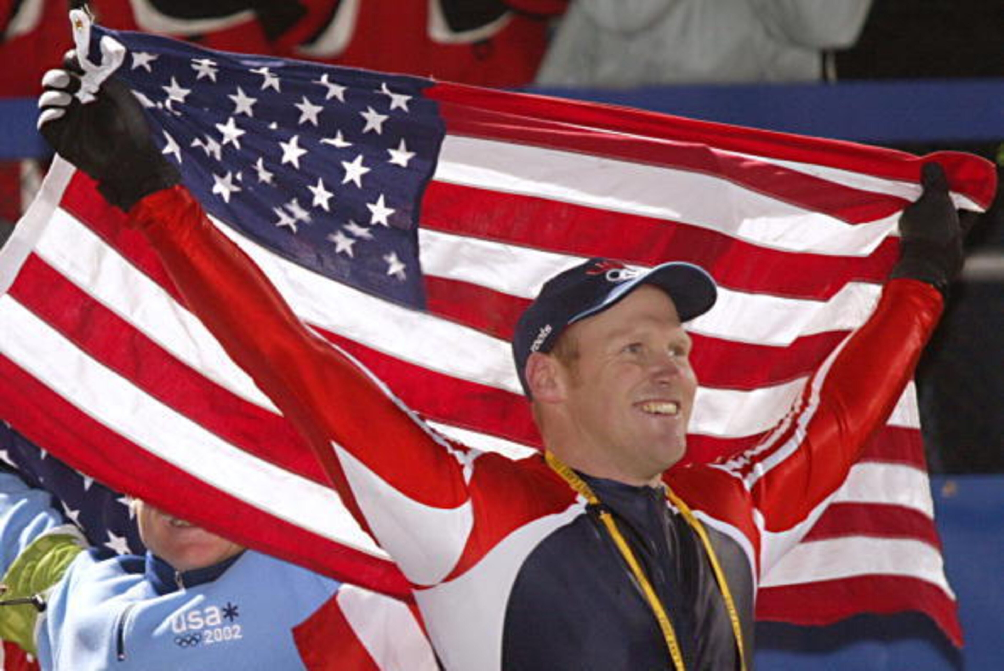 PARK CITY, UNITED STATES:  Brian Shimer the pilot for USA 2  celebrates his team's third place to win the bronze medal  during the flower ceremony for the four-man bobsleigh event  in the Salt Lake 2002 Olympic Winter Games at the Utah Olympic Park, 23 Fe