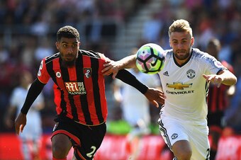BOURNEMOUTH, ENGLAND - AUGUST 14:  Lewis Grabban of AFC Bournemouth challenges for the ball with Luke Shaw of Manchester United during the Premier League match between AFC Bournemouth and Manchester United at Vitality Stadium on August 14, 2016 in Bournem