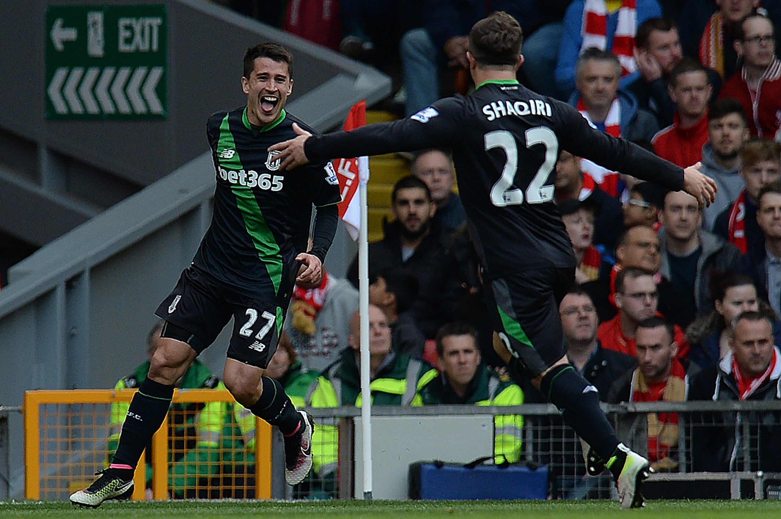 Stoke City's Spanish striker Bojan Krkic (L) celebrates scoring his team's first goal with Stoke City's Swiss forward  Xherdan Shaqiri  during the English Premier League football match between Liverpool and Stoke City at Anfield in Liverpool, northwest En