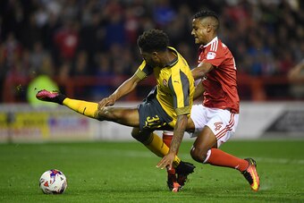NOTTINGHAM, ENGLAND - SEPTEMBER 20: Chuba Akpom of Arsenal is brought down by Michael Mancienne of Nottingham Forest leading to a penalty during the EFL Cup Third Round match between Nottingham Forest and Arsenal at City Ground on September 20, 2016 in No